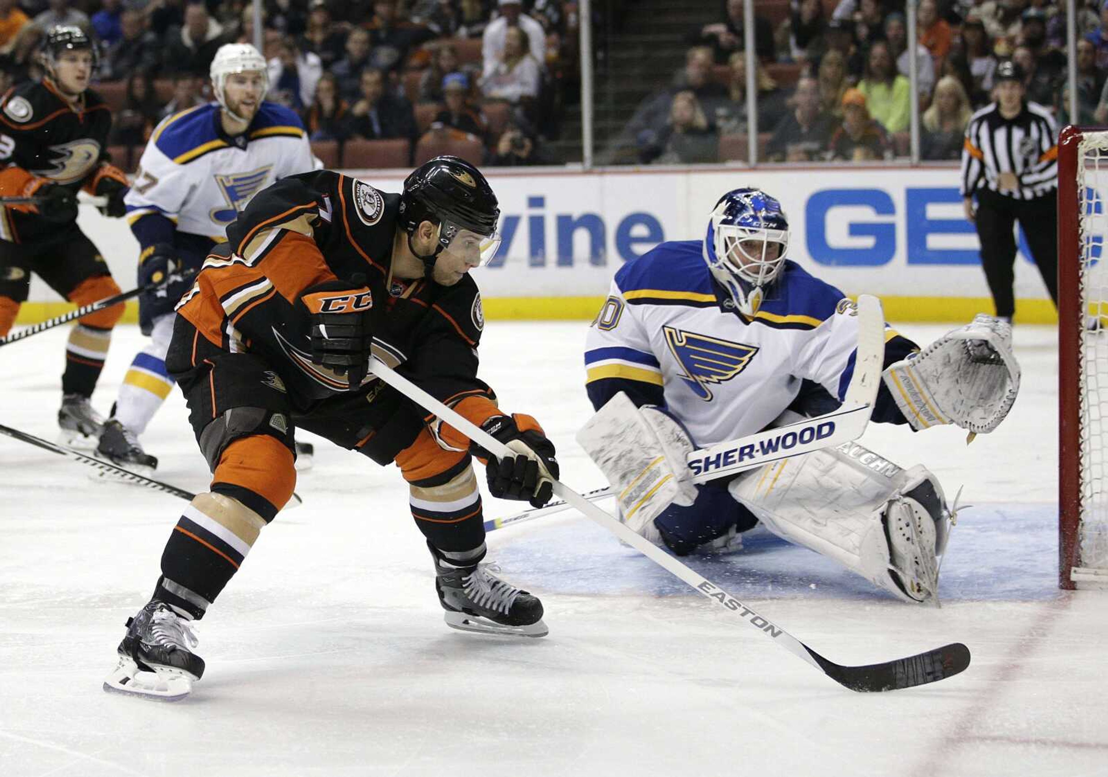 The Ducks' Andrew Cogliano, left, moves the puck as Blues goalie Martin Brodeur watches during the second period of Friday's game in Anaheim, California. (Jae C. Hong ~ Associated Press)