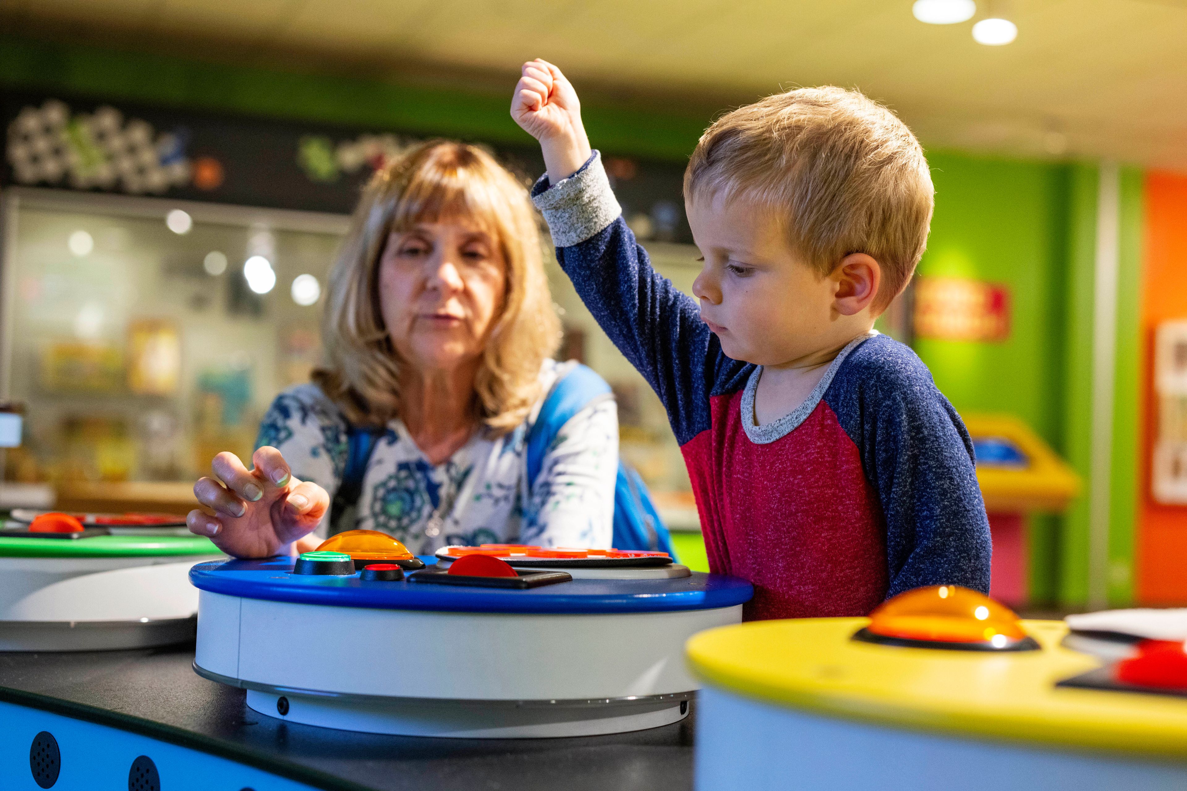 Rita Wilks plays a game of Bingo with her grandson, Oliver, 2, while visiting The Strong National Museum of Play, Tuesday, Oct. 15, 2024, in Rochester, N.Y. (AP Photo/Lauren Petracca)