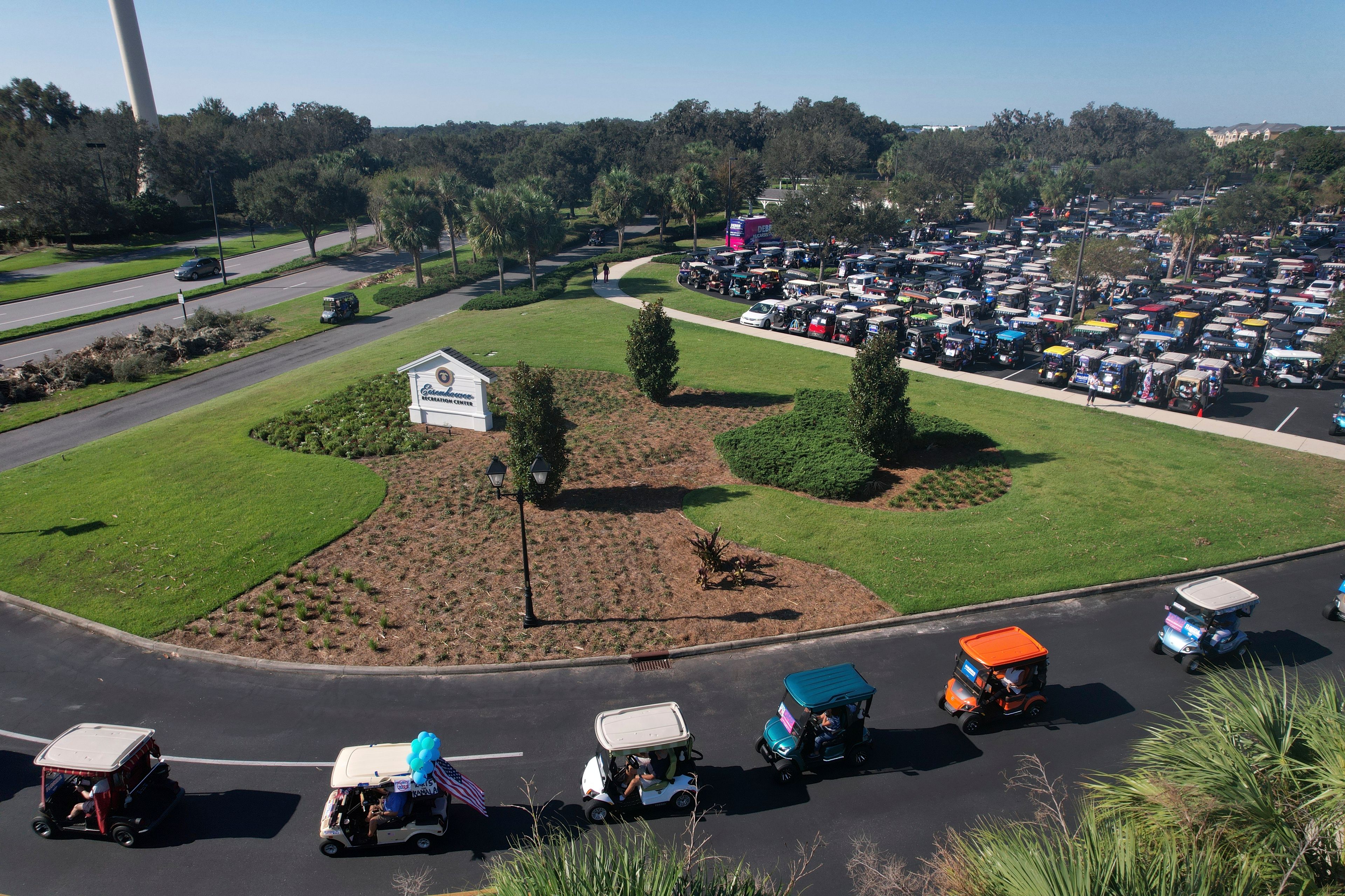 Hundreds of supporters of Democratic presidential nominee Vice President Kamala Harris participate in a golf cart parade to deliver their completed mail-in ballots, in The Villages, Fla., Monday, Oct. 14, 2024. The Villages, one of the world's largest retirement communities, has long been known as a conservative stronghold, but Democrats energized by Harris' candidacy have quietly become more visible. (AP Photo/Rebecca Blackwell)