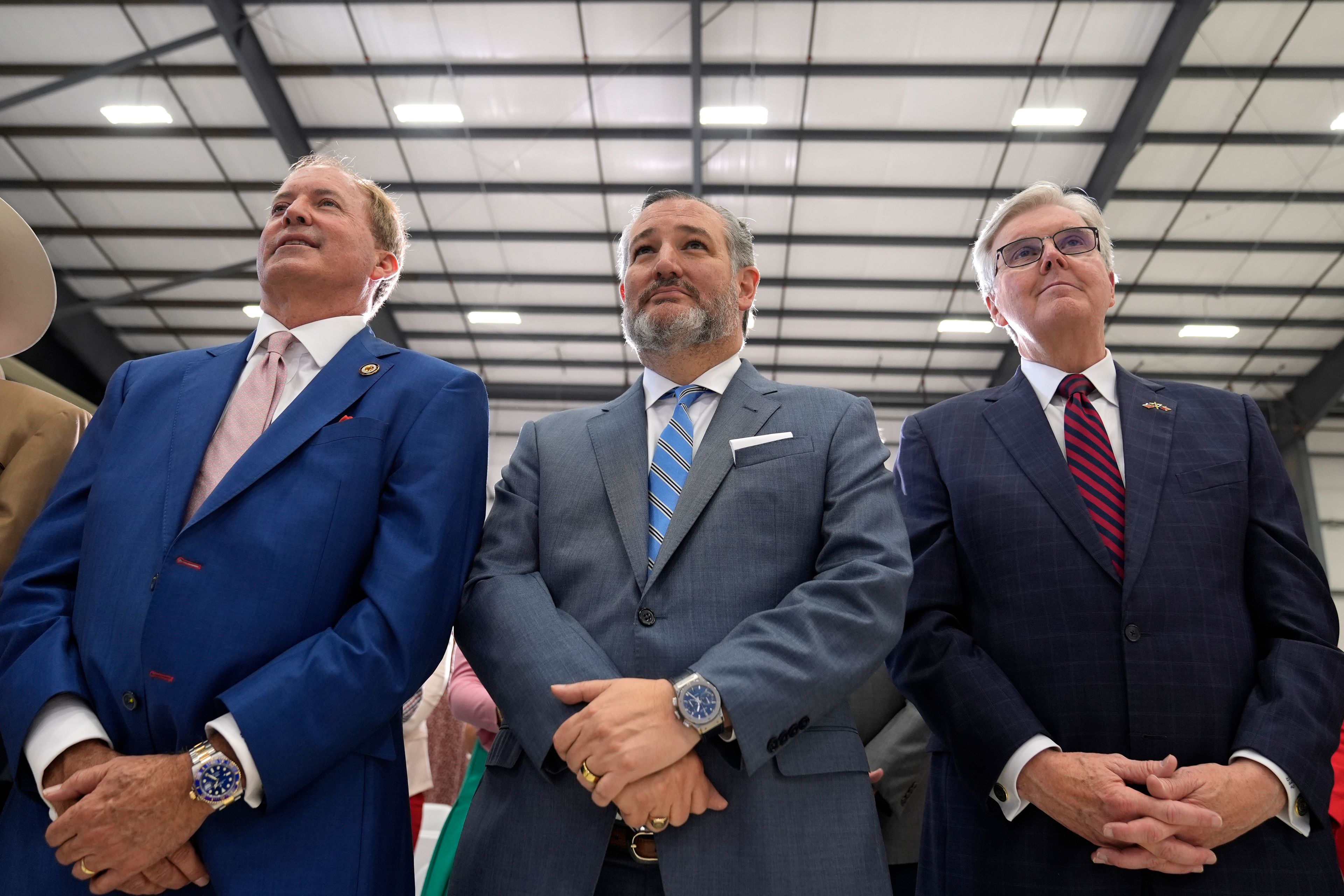 Sen. Ted Cruz, R-Texas, center, listens as Republican presidential nominee former President Donald Trump speaks during a news conference at Austin-Bergstrom International Airport, Friday, Oct. 25, 2024, in Austin, Texas. (AP Photo/Alex Brandon)