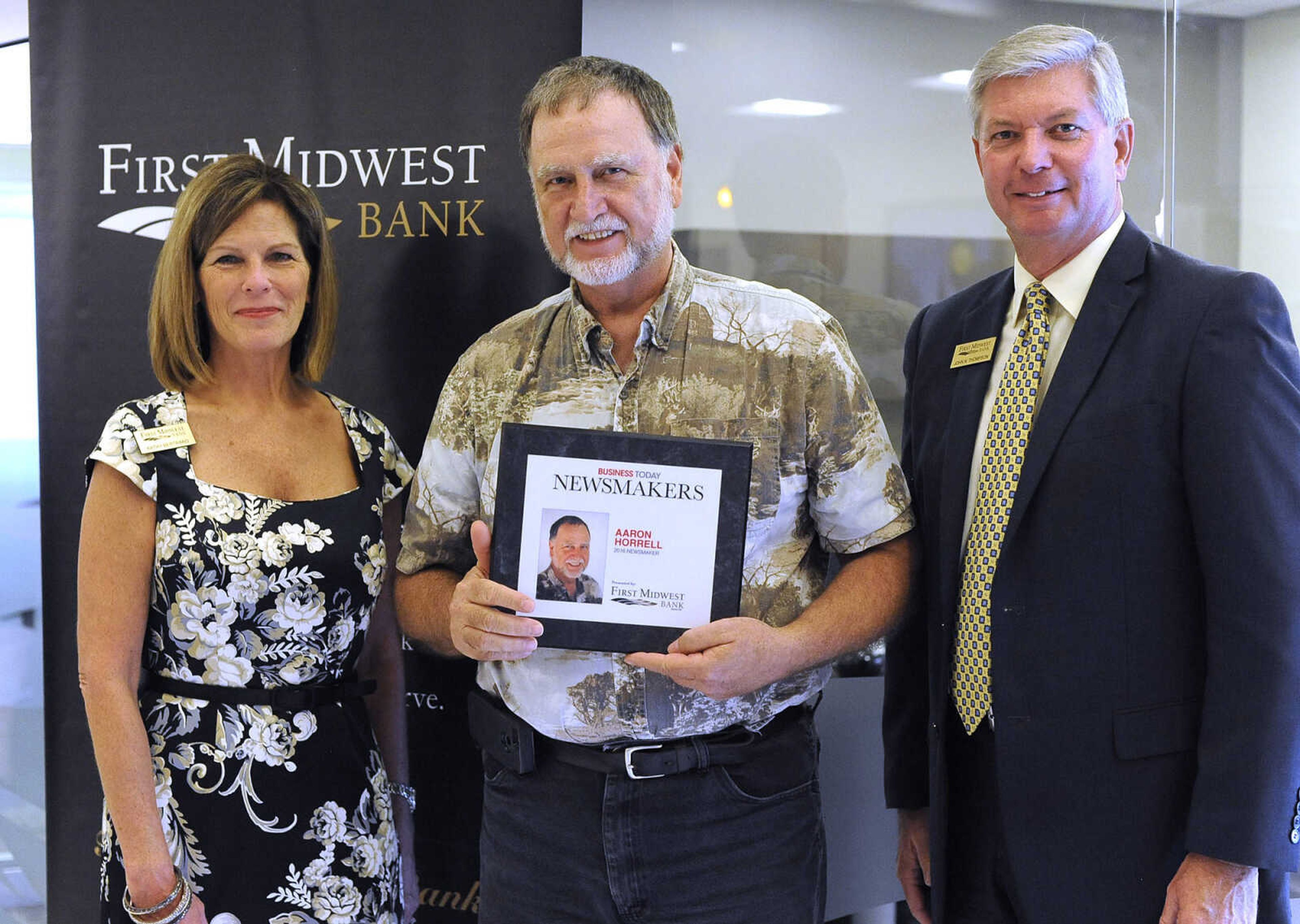 Aaron Horrell poses for a photo with Kathy Bertrand, First Midwest Bank community bank president, Cape Girardeau, and John N. Thompson, First Midwest Bank community bank president, Jackson, Wednesday, Sept. 7, 2016 during the Business Today Newsmakers awards reception at First Midwest Bank in Cape Girardeau.