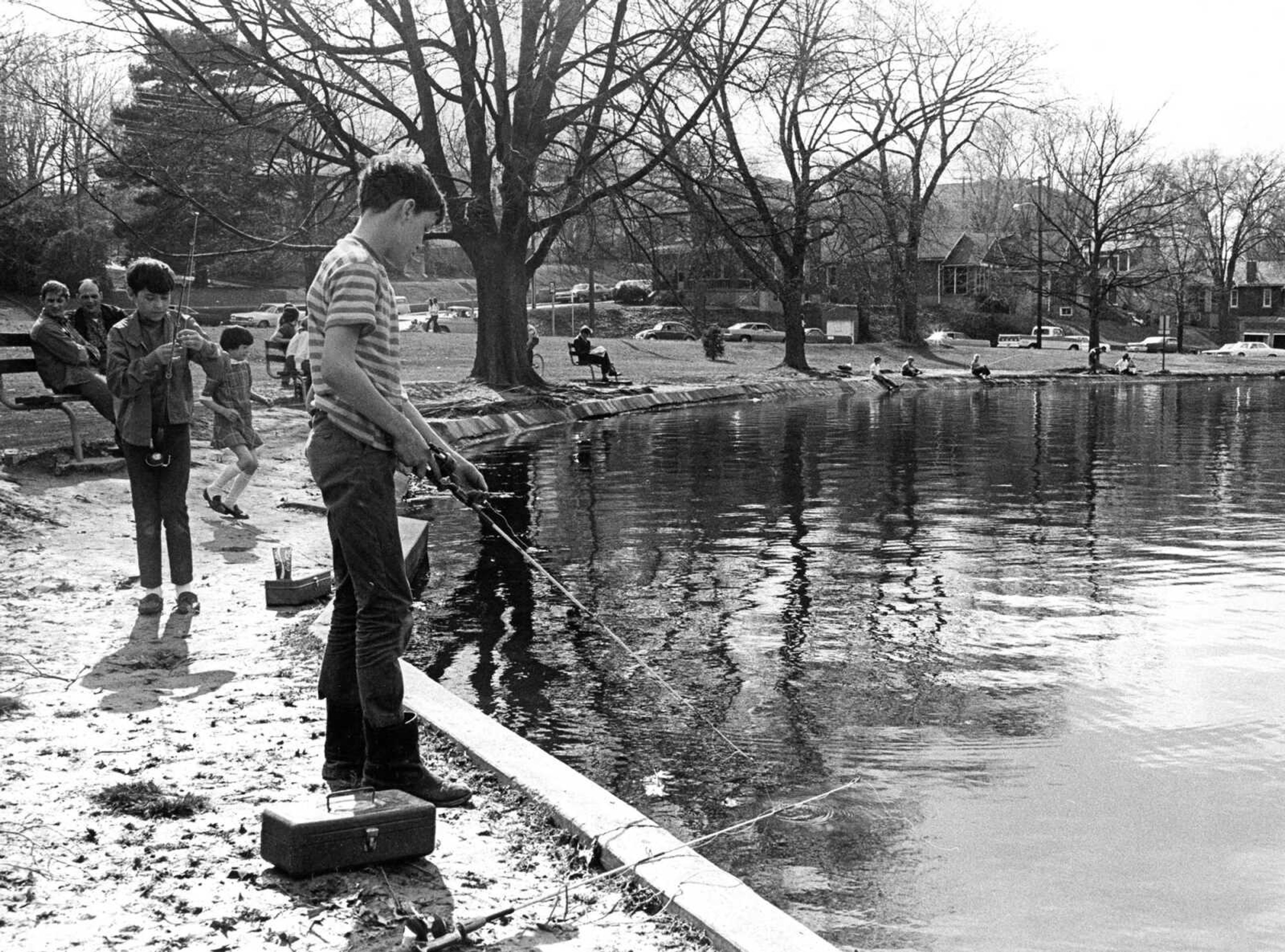 Published March 15, 1971.
Sunday was a pleasant day for a variety of outdoor activities, including flying kites and fishing, as temperatures soared into the 70s before a nighttime thunderstorm. The weekend's mild weather gave Girardeans the first real taste of spring, which was officially just a week away. Fishing in the Capaha Park Lagoon were Brian Jones and Allen Niswonger. Note the houses lining Broadway in the background of the photo. (Steve Robertson ~ Southeast Missourian archive)