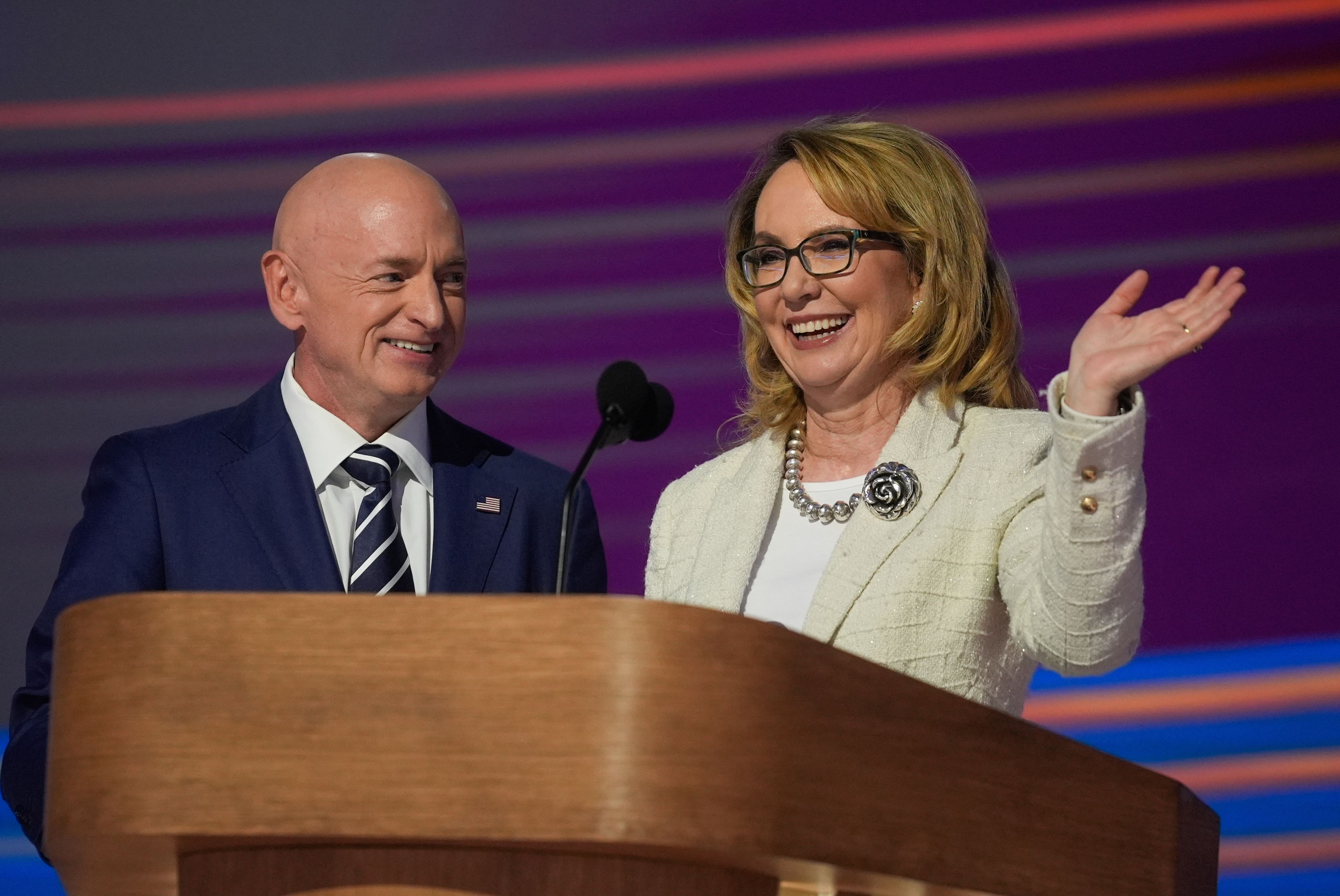 Former Rep. Gabrielle Giffords, of Arizona, right, and her husband Sen. Mark Kelly, D-Ariz., appear during the Democratic National Convention Thursday, Aug. 22, 2024, in Chicago. (AP Photo/Erin Hooley)