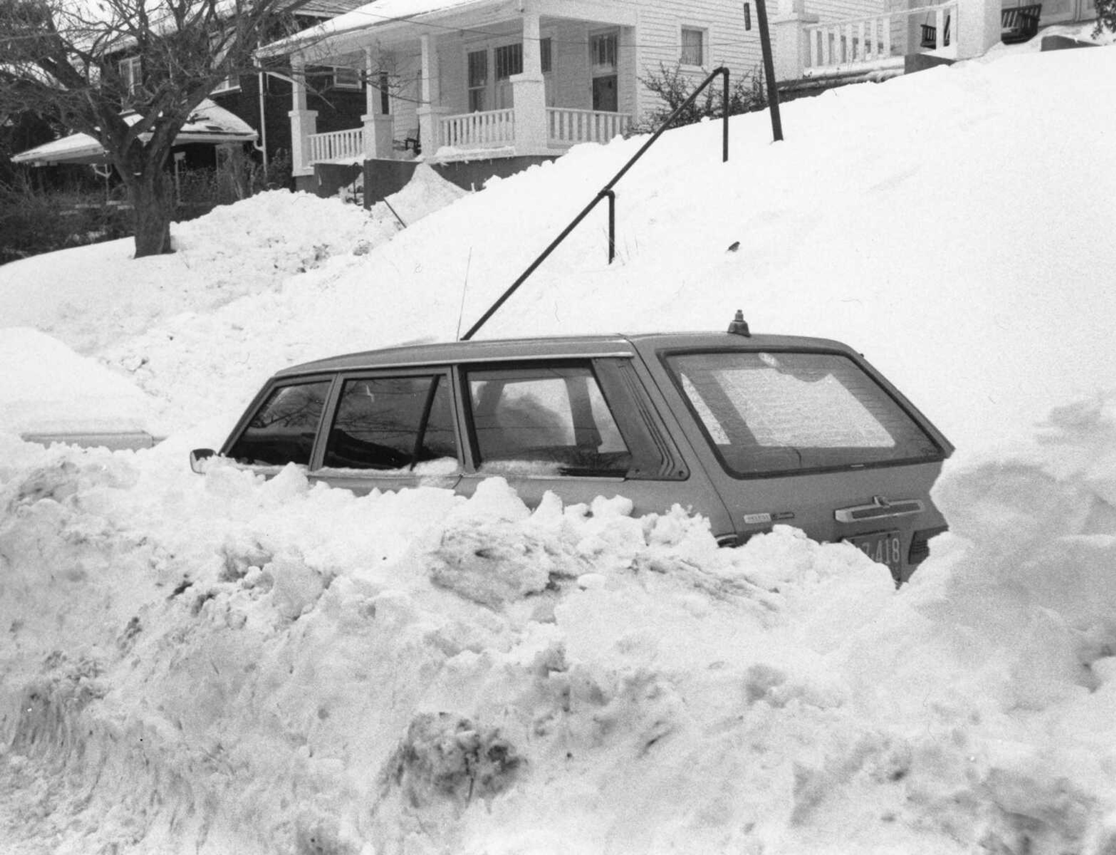 This scene was repeated many times in Cape Girardeau during the Blizzard of '79. This vehicle, like hundreds of others, was trapped by drifted and plowed snow. The photo was taken on Broadway near Perry Avenue. (Southeast Missourian archive photo by Fred Lynch)