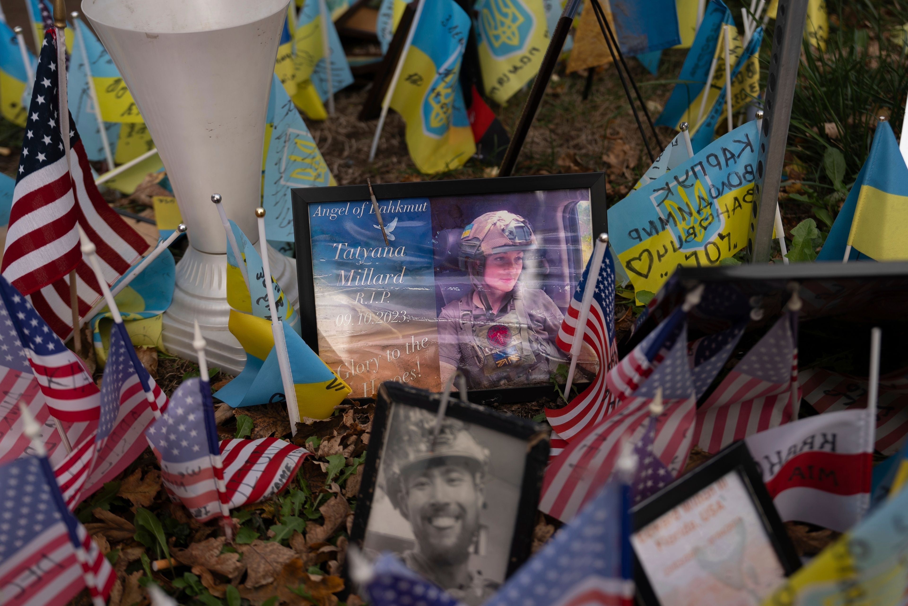 The memorial plate for Tatyana Millard, American volunteer, is seen among Ukrainian and American flags placed in honour of fallen servicemen in central Kyiv, Ukraine, Tuesday, Nov. 5, 2024. (AP Photo/Alex Babenko)