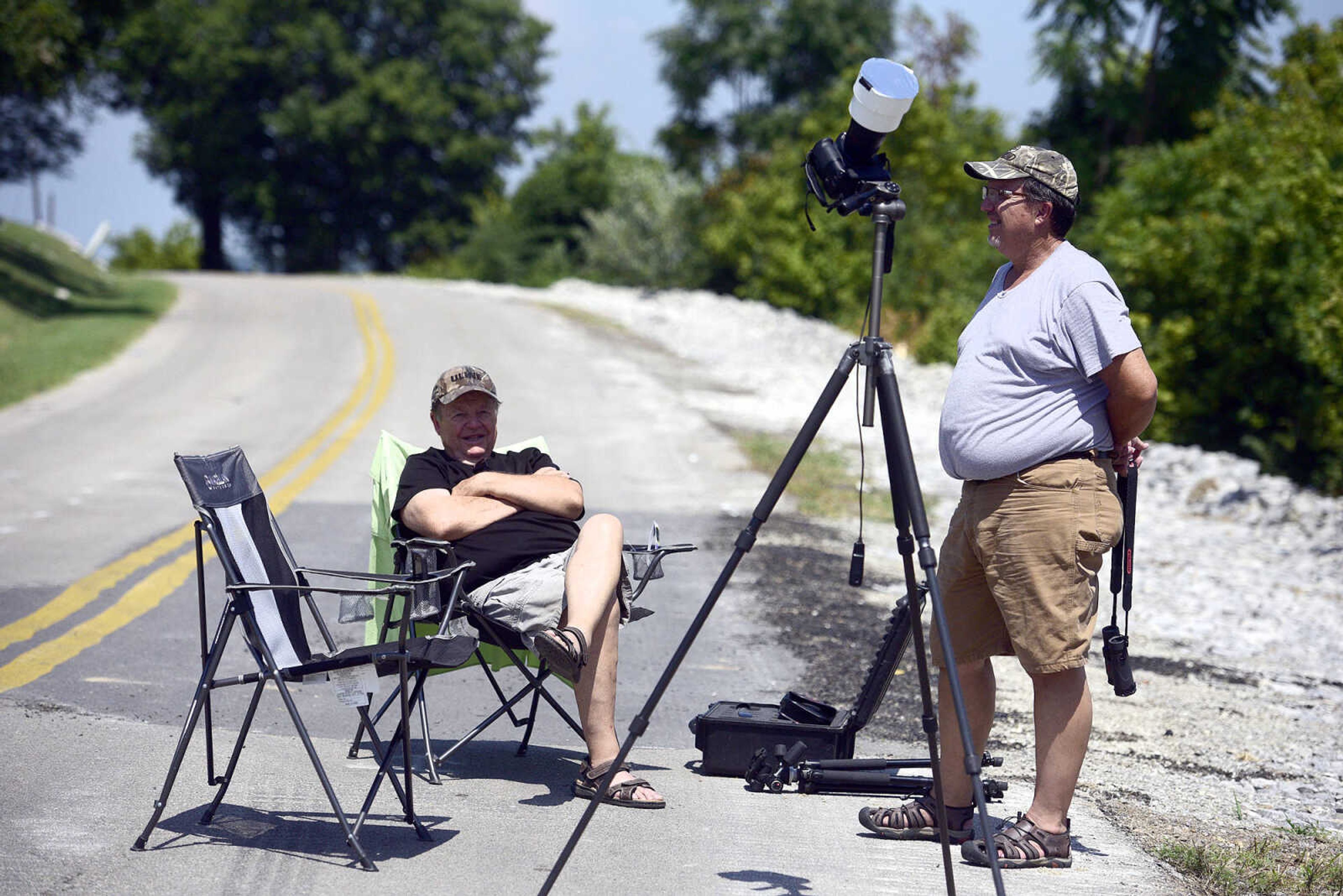 Ed Rothenberger, left, and his son Brick take their viewing spots on Aquamsi Street for the solar eclipse on Monday, Aug. 21, 2017, in Cape Girardeau.