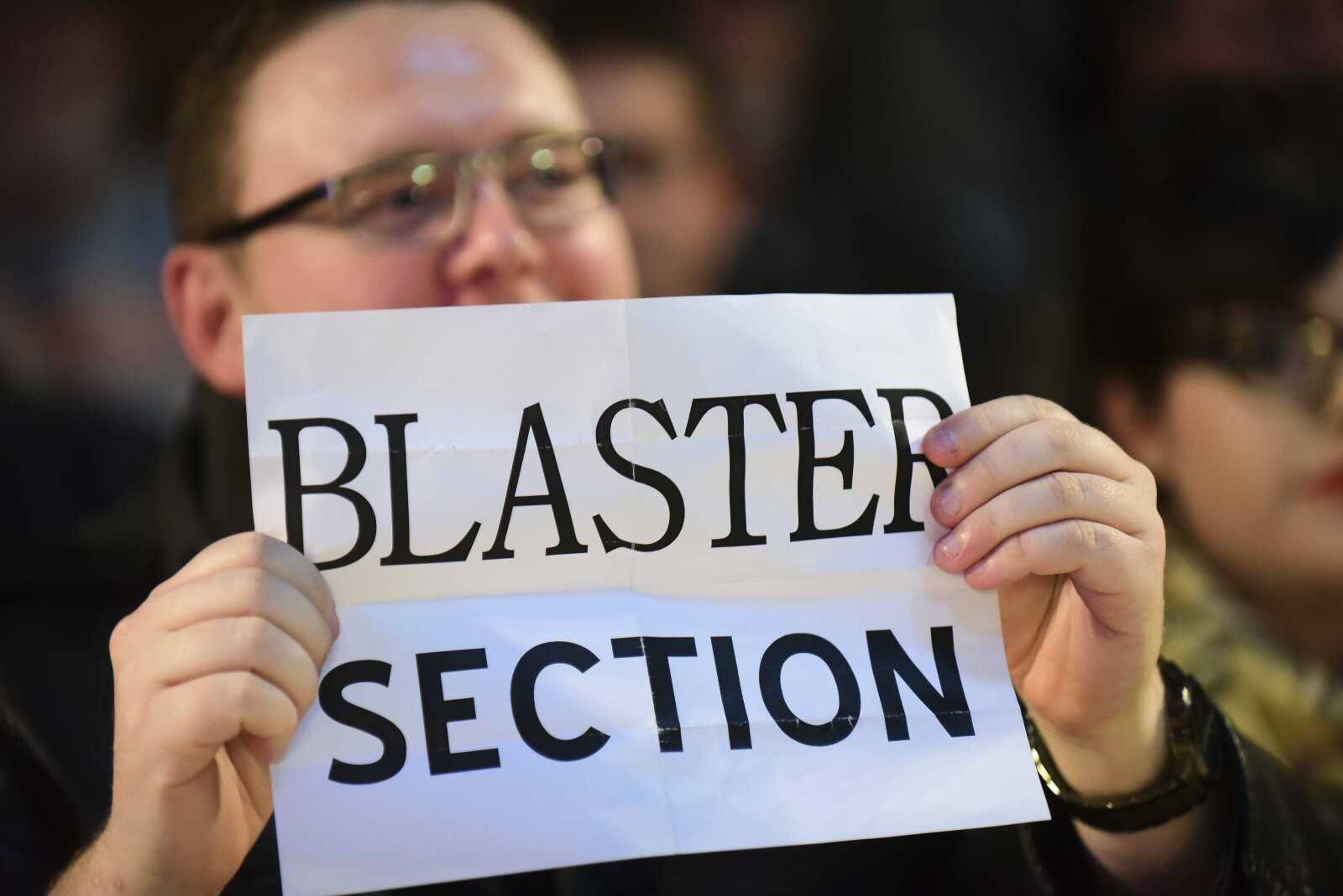 A fan holds a sign reading "Blaster Section" as Blaster enters the arena during the Cape Championship Wrestling match Saturday at the Arena Building in Cape Girardeau.