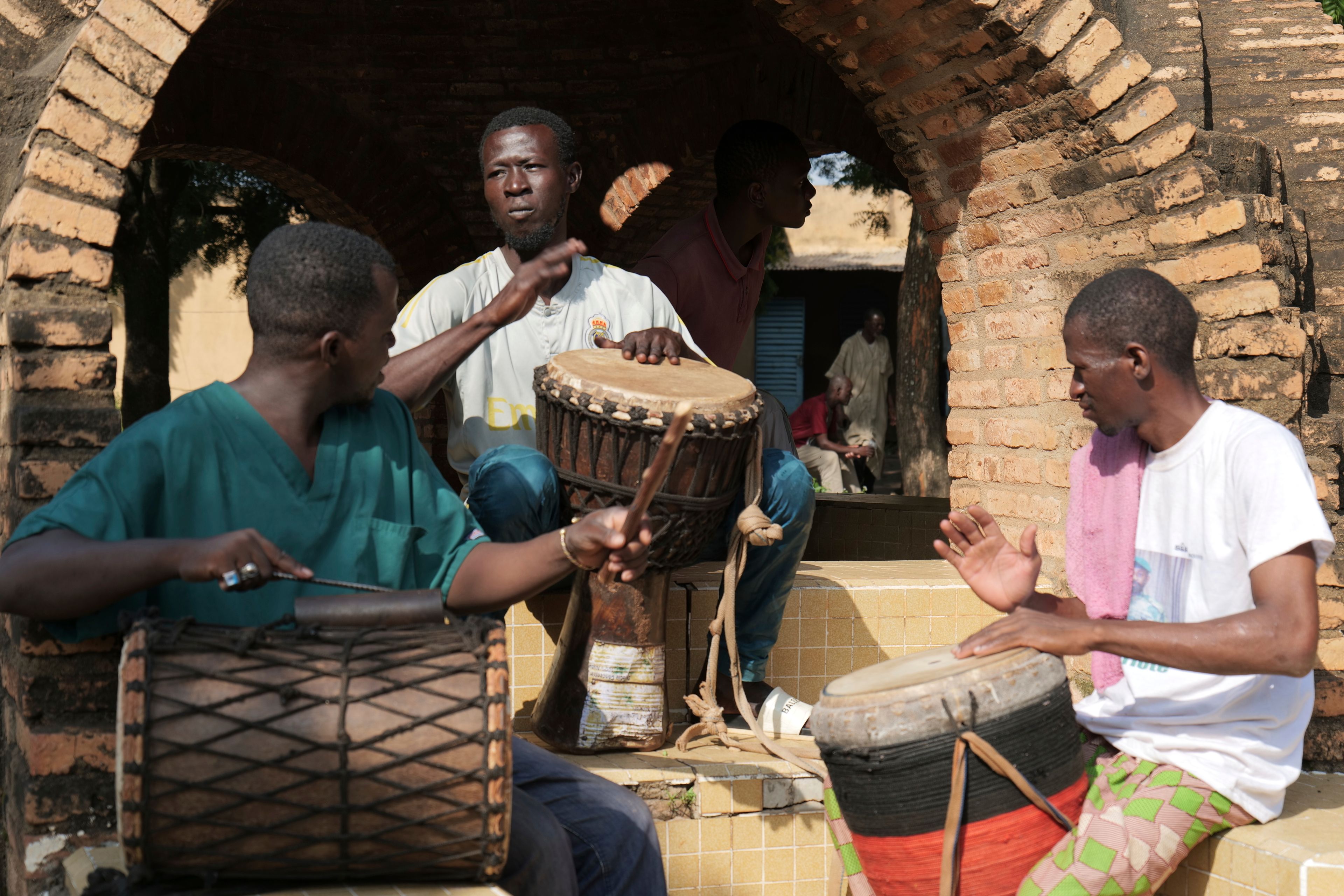 Patients at Bamako's Point G psychiatric ward play instruments in the hospital's courtyard in Bamako, Mali, Friday, Sept. 20, 2024. (AP Photo/Moustapha Diallo)