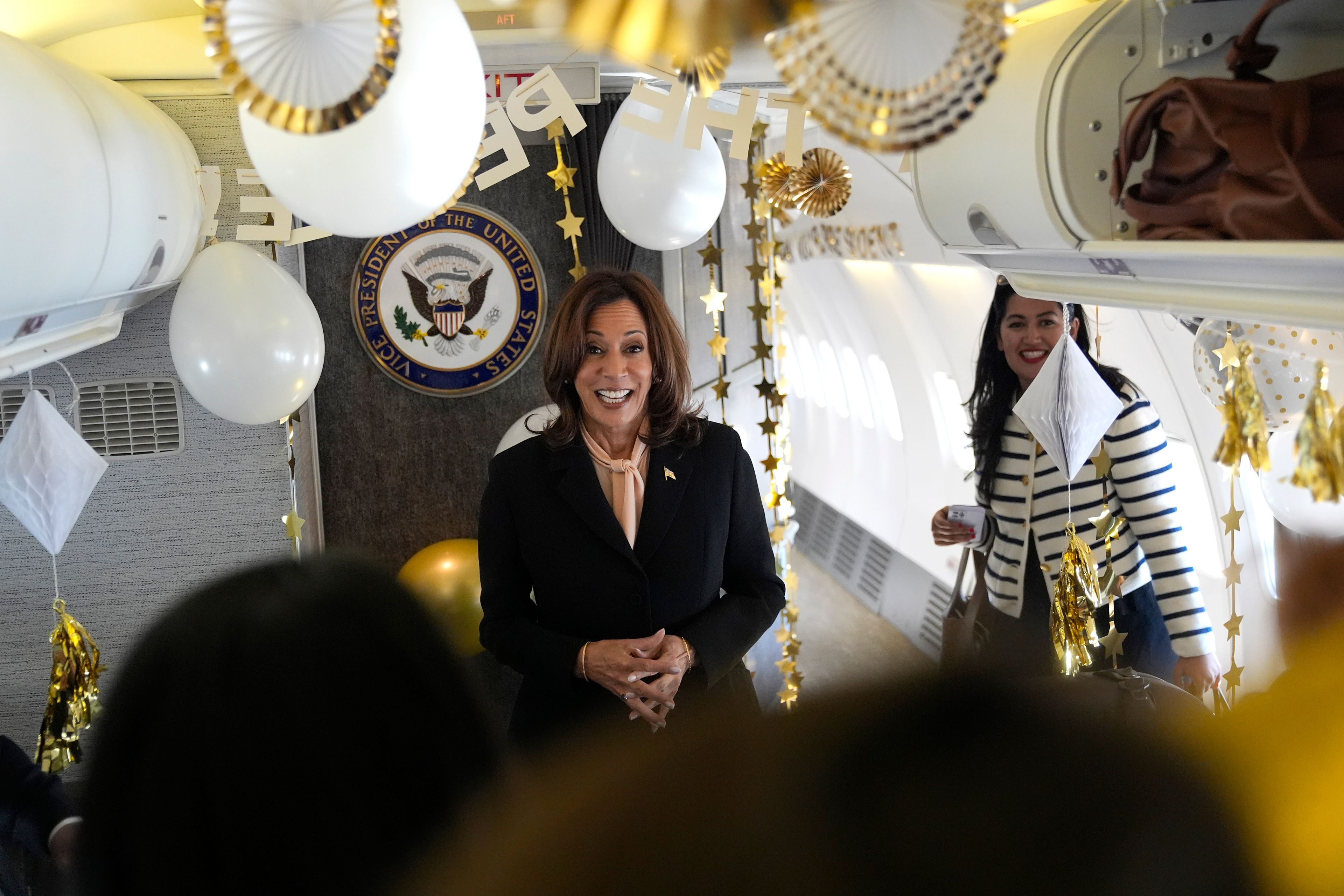 Democratic presidential nominee Vice President Kamala Harris is surprised by campaign staff with birthday decorations on Air Force Two before departing Hartsfield Jackson International Airport in Atlanta, Sunday, Oct. 20, 2024, en route to Philadelphia. (AP Photo/Jacquelyn, Martin, Pool)