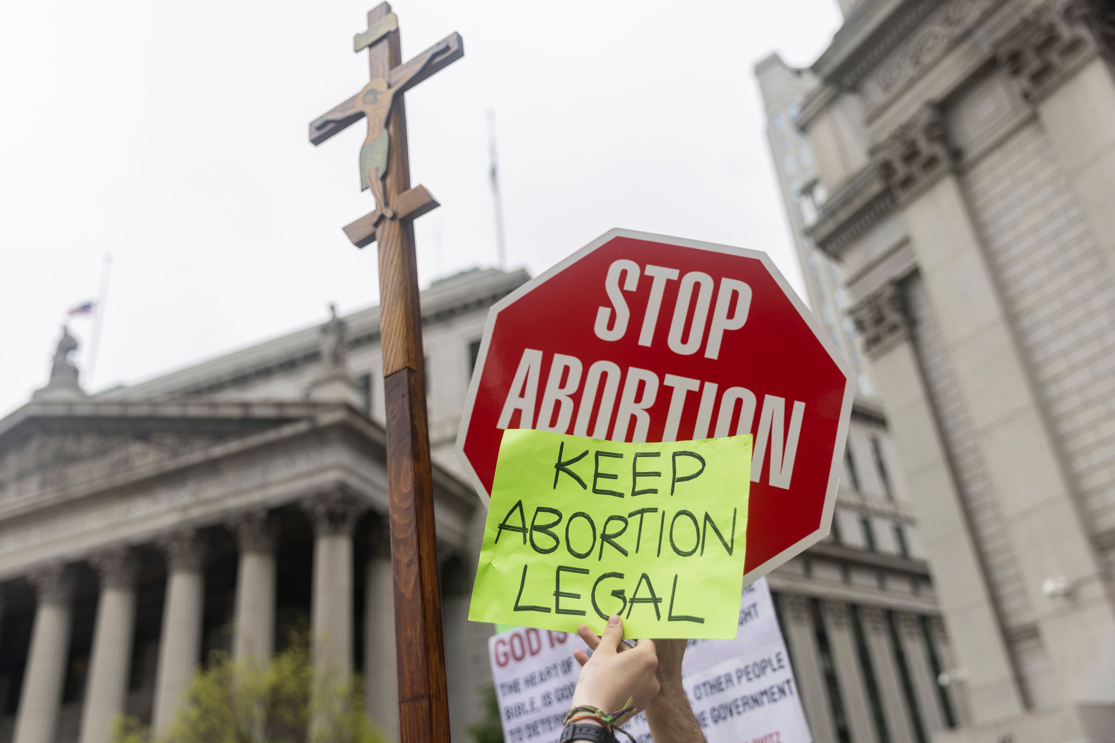 FILE - Protesters hold competing signs outside Manhattan federal court during an abortion-rights demonstration in New York, Saturday, May 14, 2022. (AP Photo/Jeenah Moon, File)