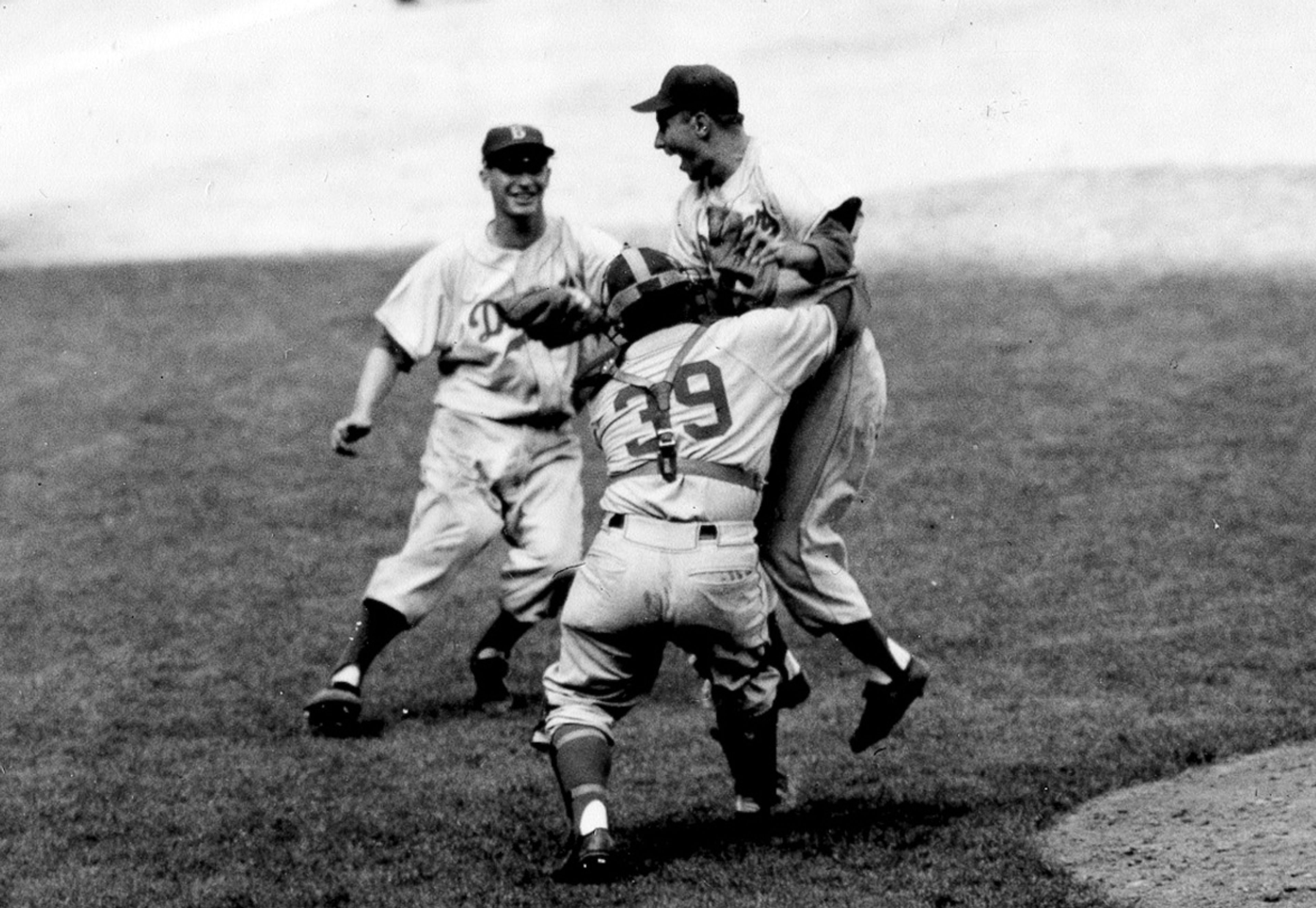 FILE - Brooklyn Dodgers pitcher Johnny Podres is lifted by catcher Roy Campanella (39) after the final out of the seventh and deciding game of the World Series at Yankee Stadium, Oct. 4, 1955, in New York. (AP Photo, File)