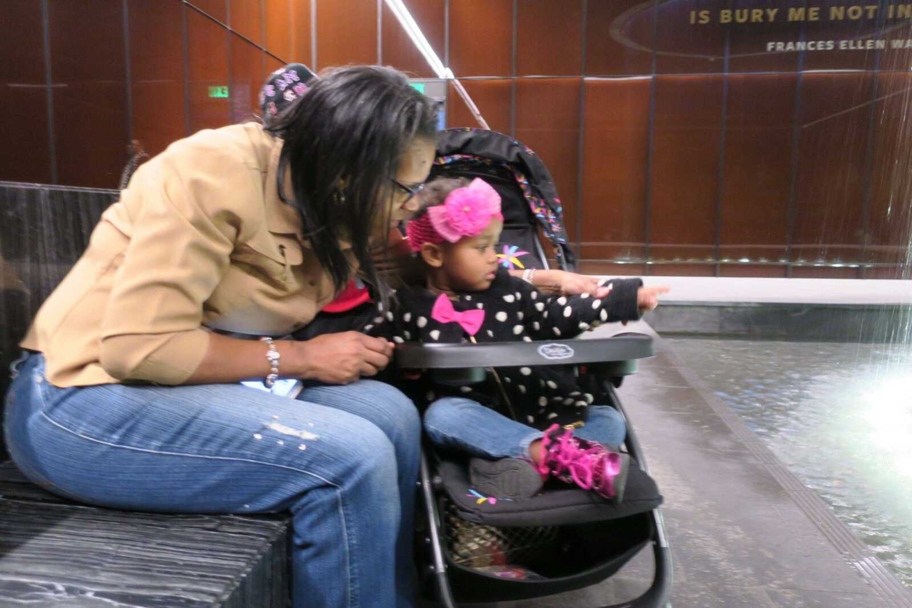 Kim Taylor, 56, talks to her great niece Monday at the Smithsonian National Museum of African-American History and Culture in Washington.