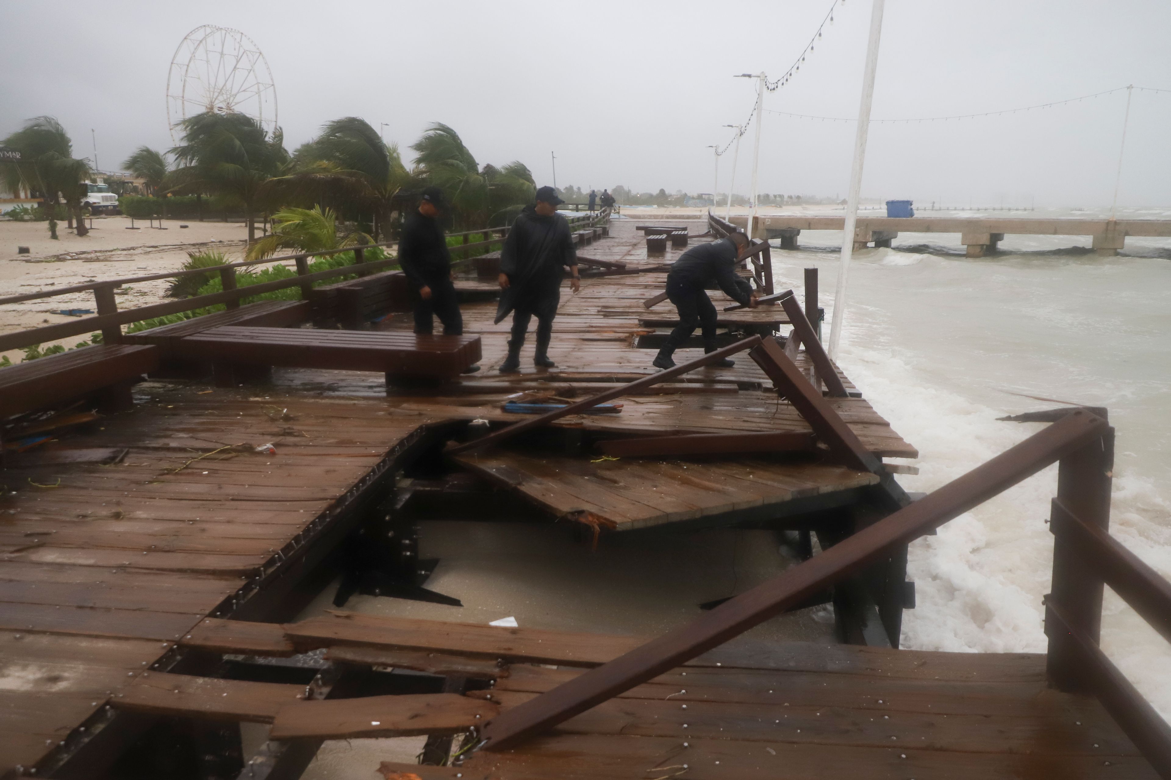 Yucatan State police inspect damage at the harbor from Hurricane Milton in Progreso, Yucatan state, Mexico, Tuesday, Oct. 8, 2024. (AP Photo/Martin Zetina)