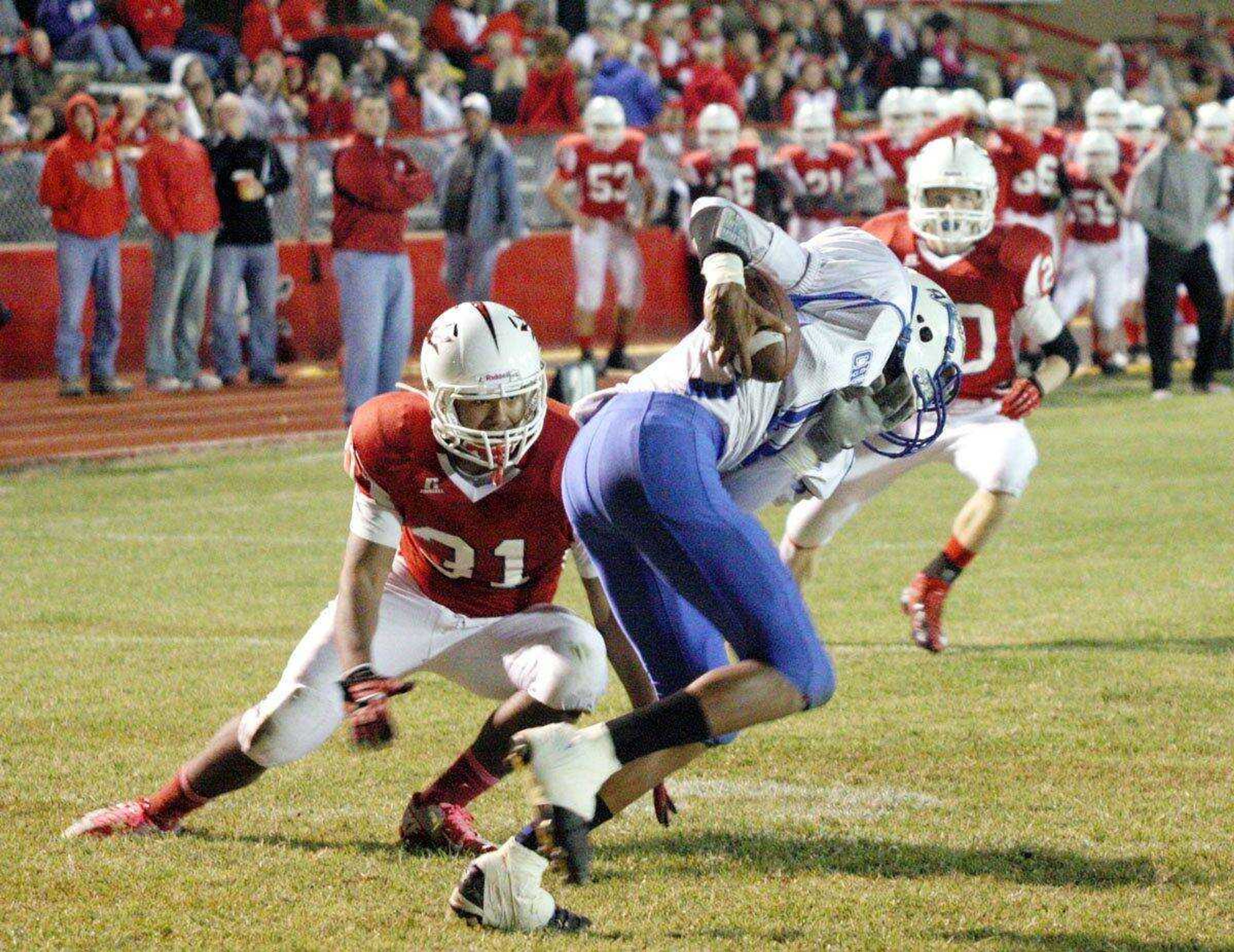 Chaffee&#8217;s Jimmy Golden, left, stares down Charleston&#8217;s Sumner Foster, center, after Foster intercepted a pass in the end zone Friday at Chaffee High School. (Chris Pobst ~ Standard-Democrat)