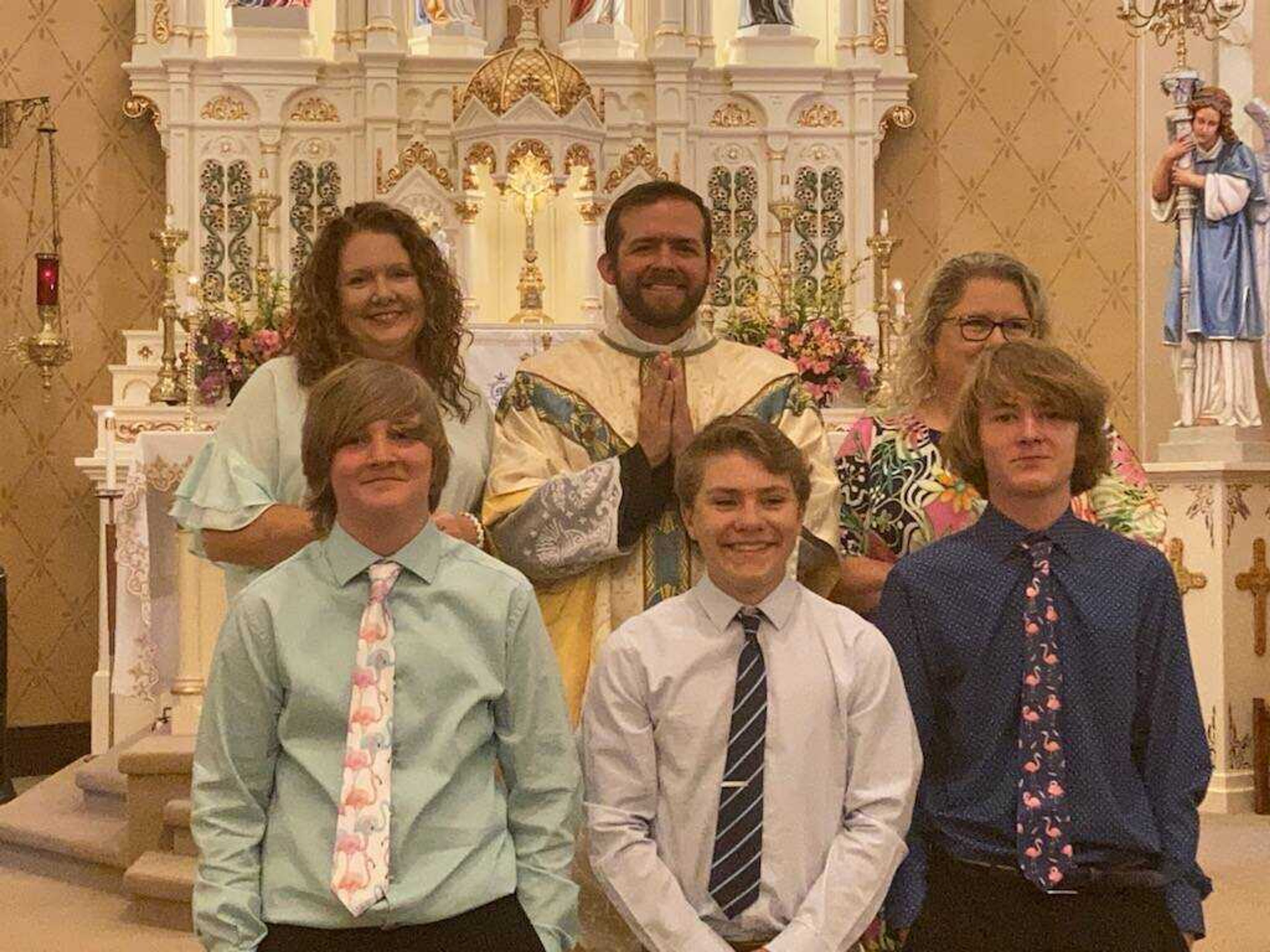 Three young men graduated from Guardian Angel School on Friday, May 12.  Pictured are (front row, left to right) Weston Woods, Jonah Dirnberger, and Porter Gadberry.  In the back row are Jodi McVay (8th grade home room teacher), Father Joseph Kelly (parish priest), and Katrina Kluesner (principal).