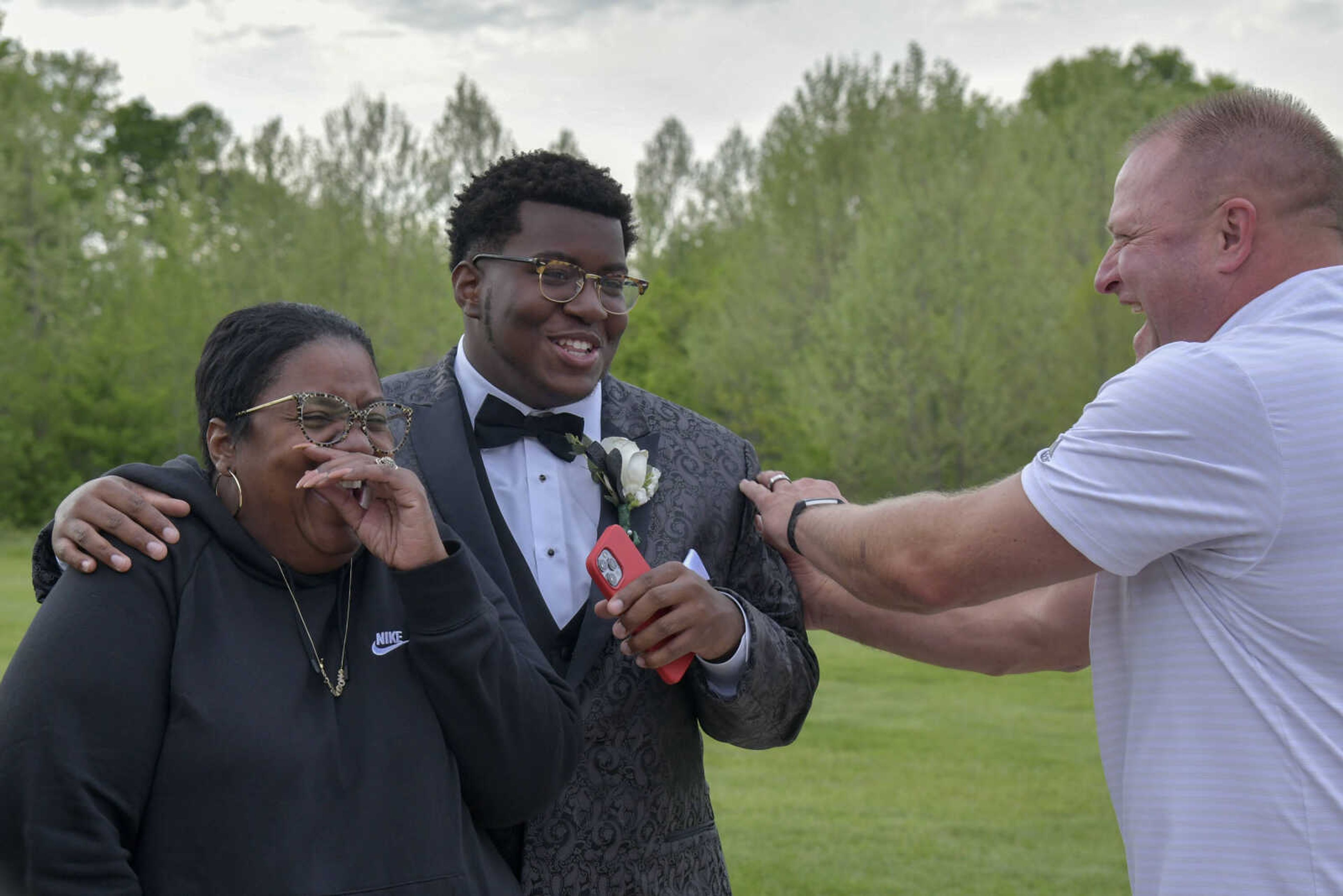 Adrena Pearson, Landon Pearson and Keith Daum, from left, share a laugh during a pre-prom event at the Dalhousie Golf Club in Cape Girardeau on Saturday, May 8, 2021.