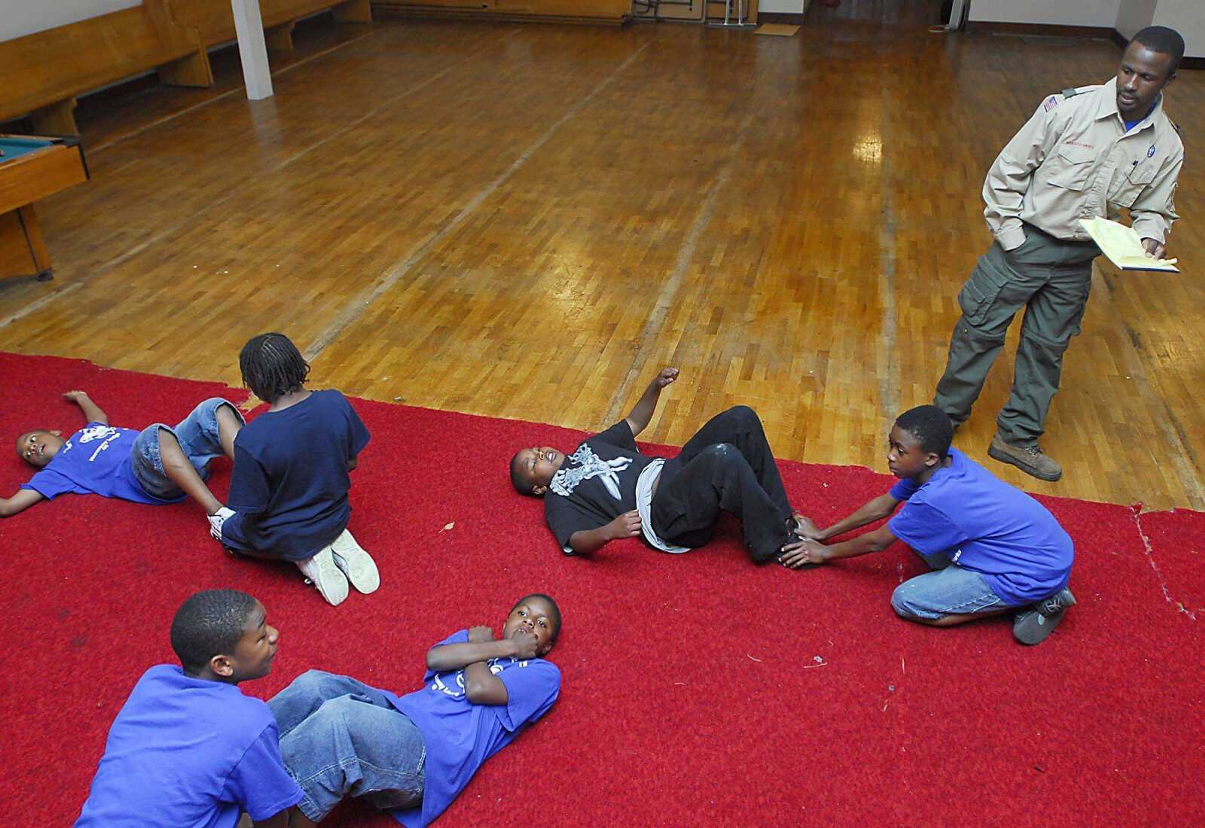 Troop 4215 Scoutmaster Jiles Tripplett with Troop 4215 oversees situps during drill Tuesday at the Cape Area Family Resource Center.  Tripplett wants the scouts to perform well in a camping trip to Trail of Tears State Park later this month. (Kit Doyle)