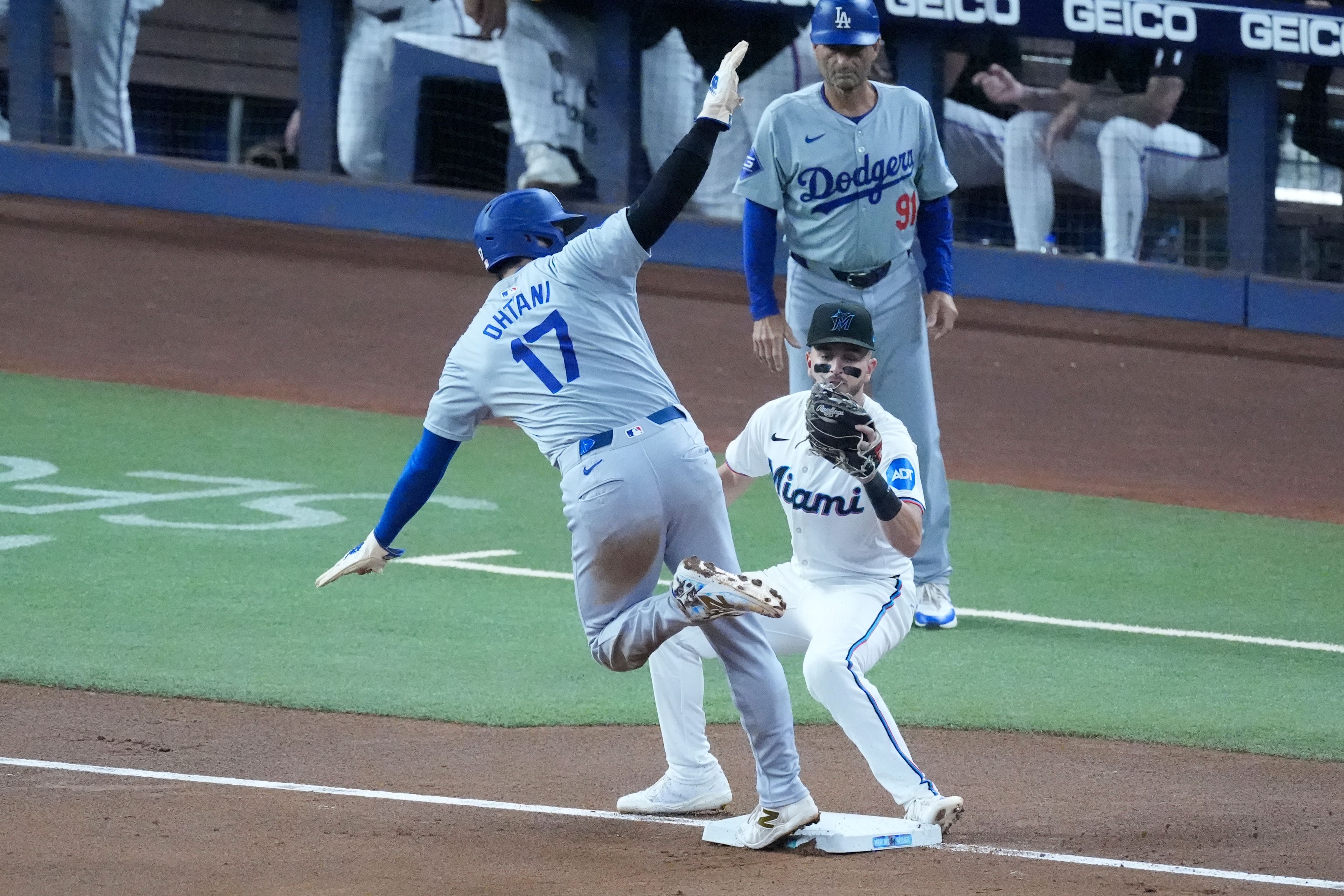 Los Angeles Dodgers' Shohei Ohtani (17) of Japan, steals third base, for his 50th stolen base of the season, as Miami Marlins third baseman Connor Norby was late with the tag during the first inning of a baseball game, Thursday, Sept. 19, 2024, in Miami. (AP Photo/Wilfredo Lee)