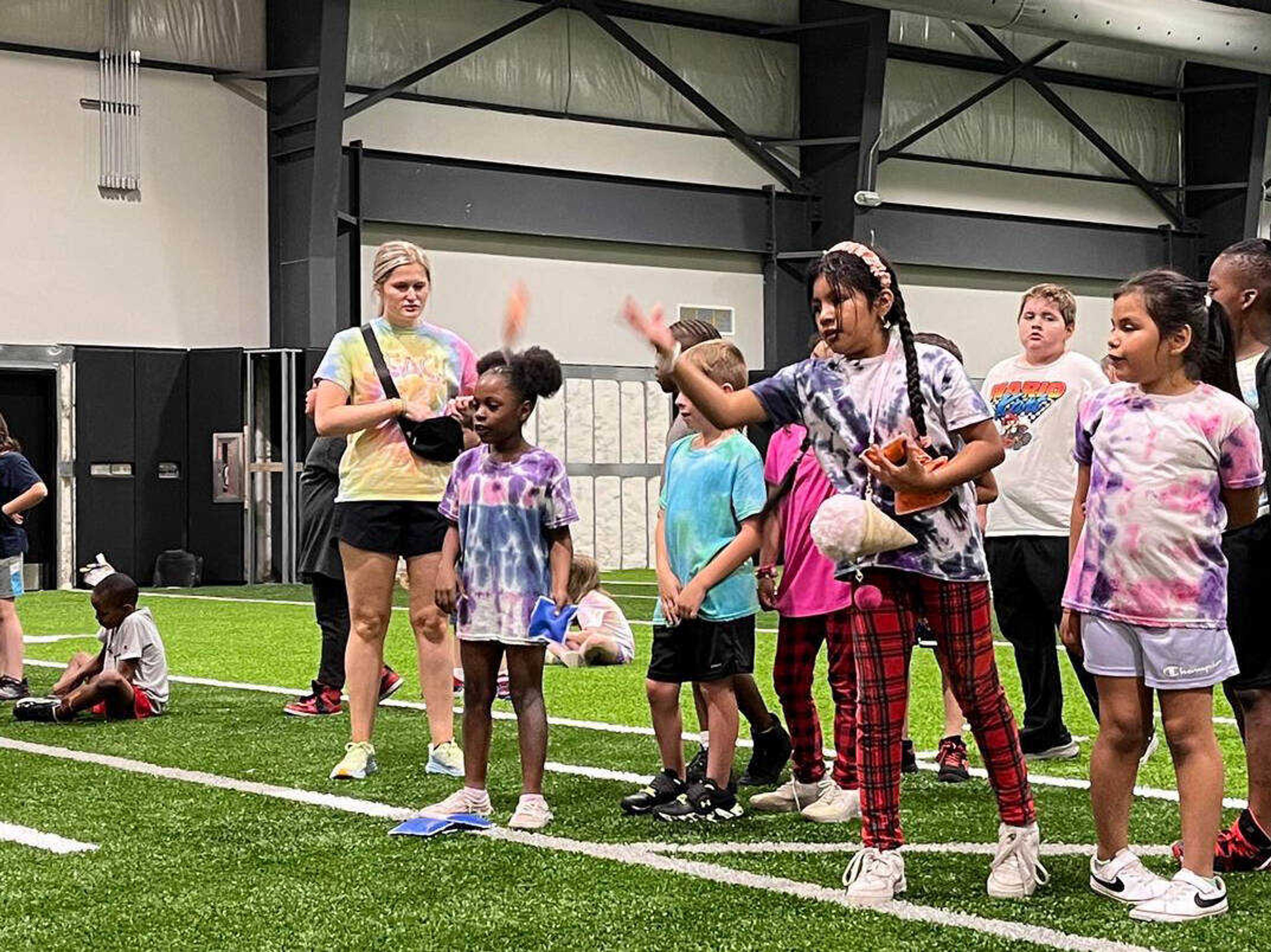 An elementary student participates in a bean-bag throwing competition during the final day of summer school Friday, June 7, at Cape Central High School in Cape Girardeau.