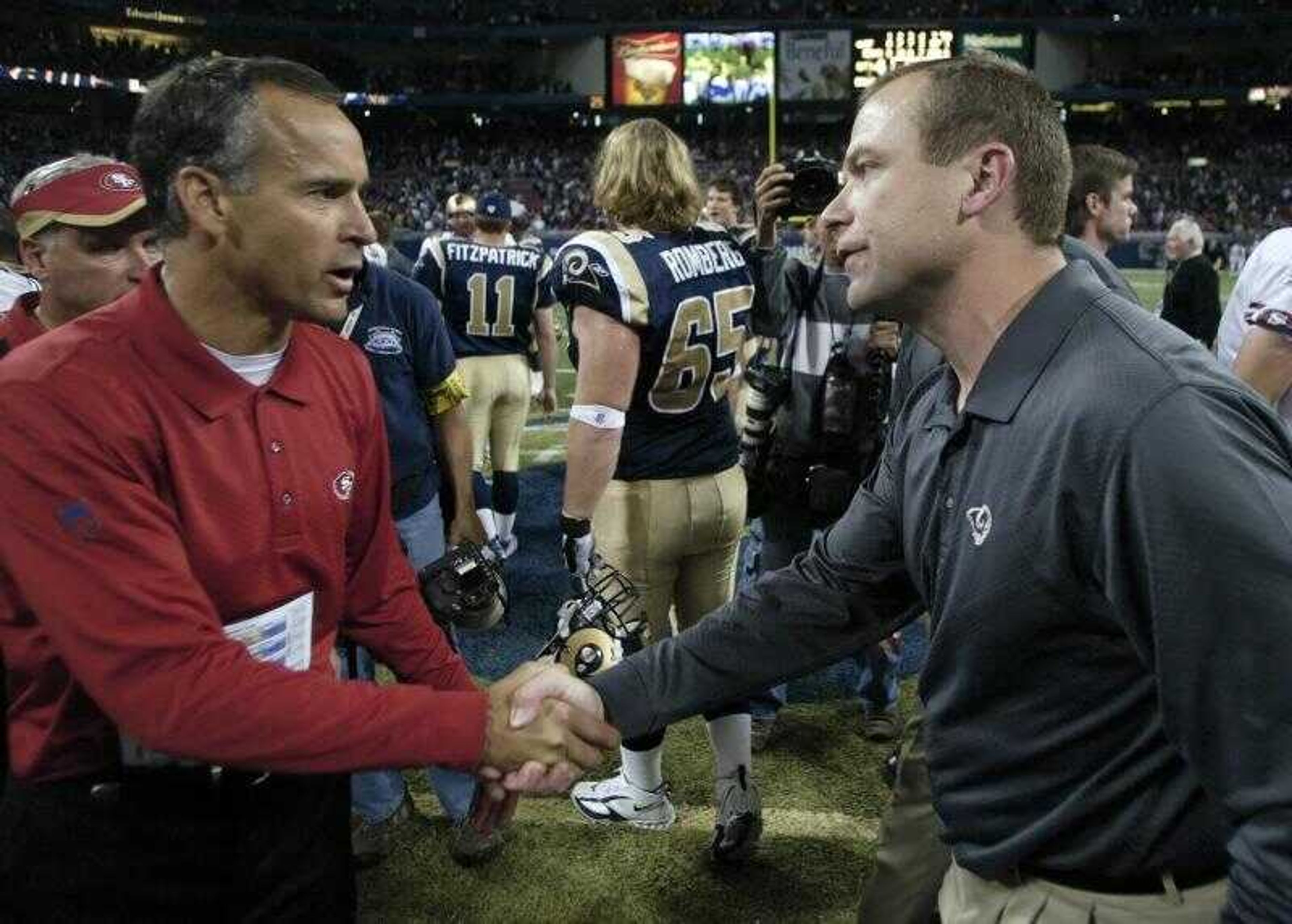 San Francisco 49ers head coach Mike Nolan, left, congratulated Rams head coach Scott Linehan at midfield after Sunday's game in St. Louis. The Rams beat the 49ers 20-17. (TOM GANNAM ~ Associated Press)