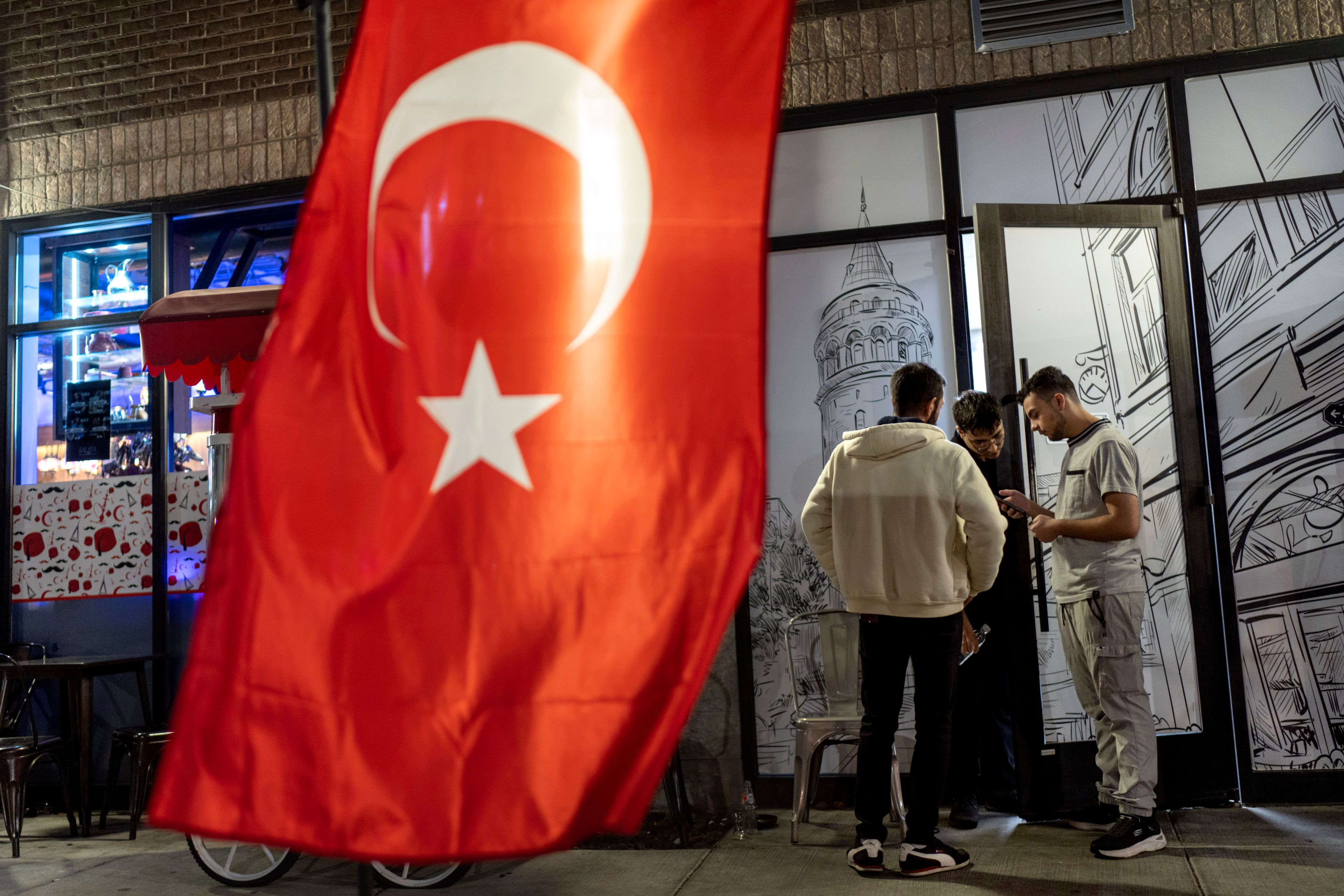 The flag of Turkey hangs as workers take a break from the dinner shift at a Turkish restaurant Wednesday, Nov. 6, 2024, in Dearborn, Mich., the nation's largest Arab-majority city. (AP Photo/David Goldman)