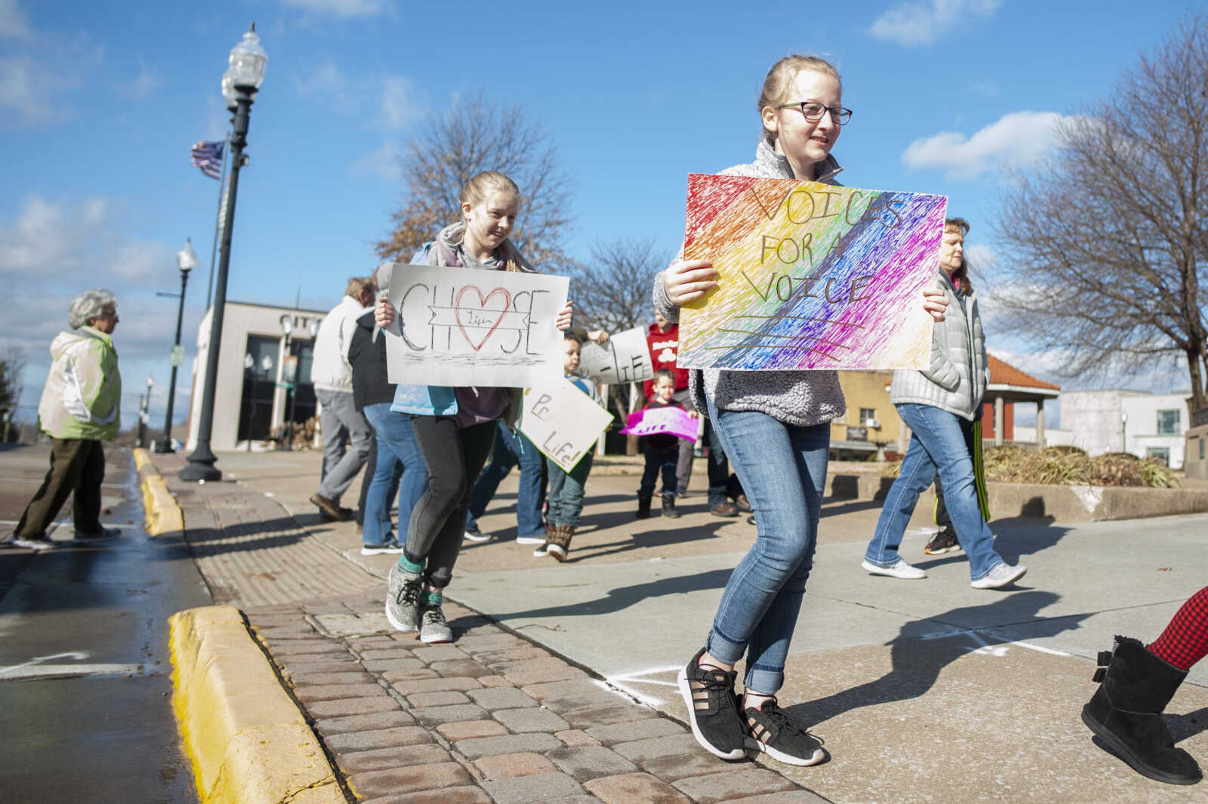 Clare Garner, 10, of Cape Girardeau, (foreground) and Emily Huff, 10, of Jackson, takes part in a March for Life on Saturday, Jan. 18, 2020, in Jackson.