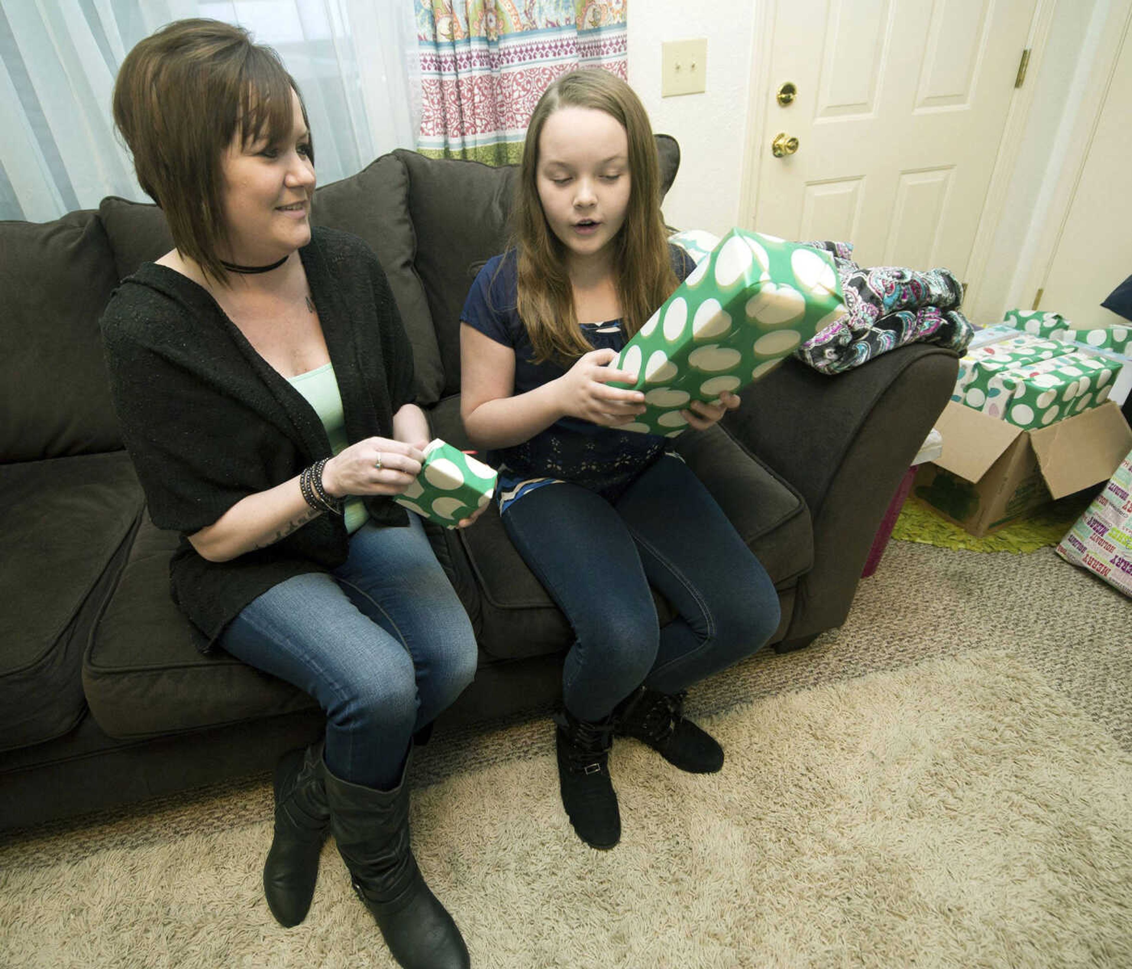 Lung-transplant recipient Caryn Durbin celebrates an early Christmas with her daughter, Bailey Artinger, 10, on Dec. 22 at her home in Joplin, Missouri. Durbin's early Christmas with family freed her up for a return trip to St. Louis for additional treatment.