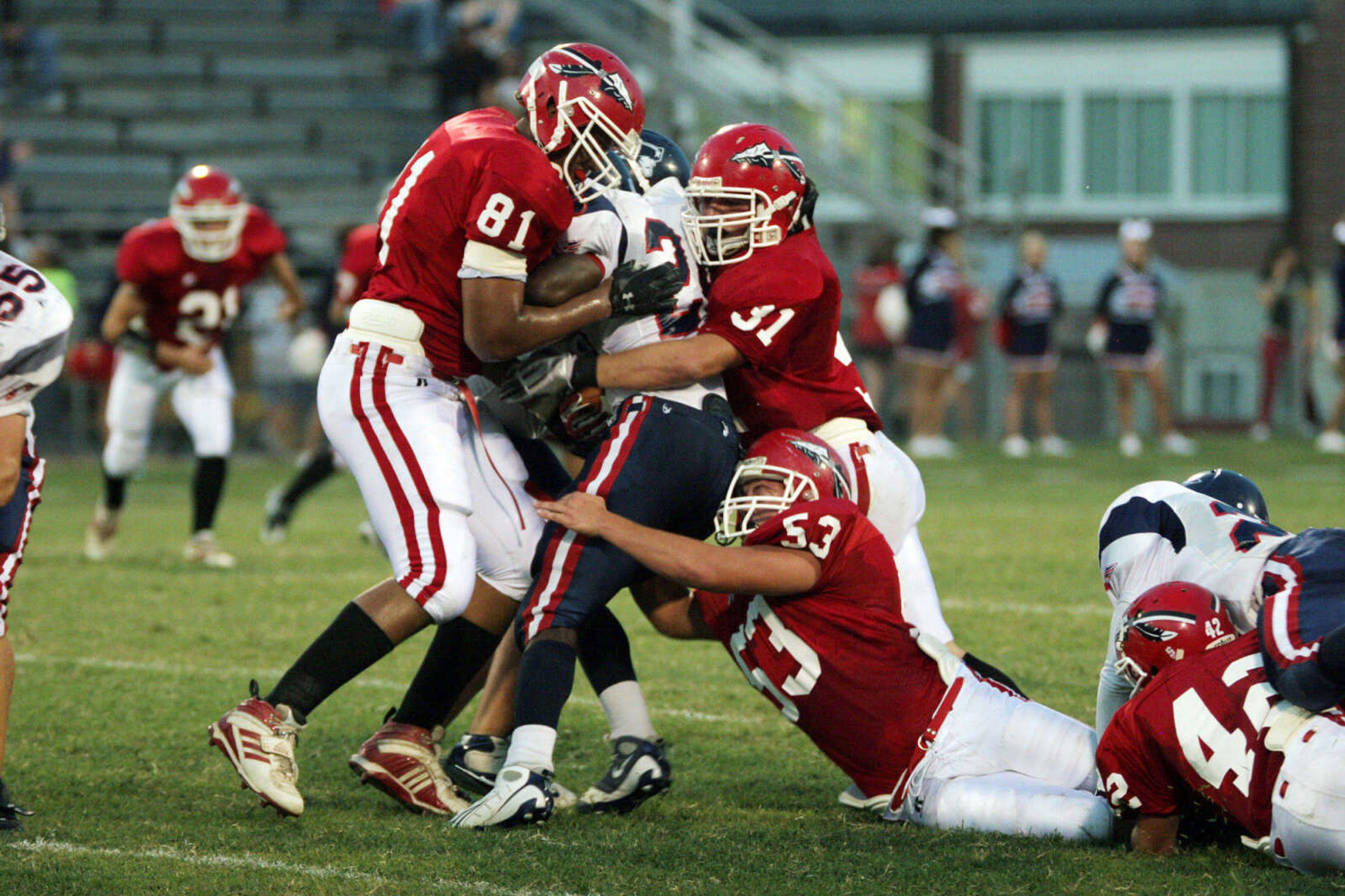 SEAN MAGEE ~ photos@semissourian.com
Parkway South's Lawrence Scott is hit from three sides by Jackson defenders Henrie Williams, left, Cole Rodgers and Dalton Cochran, below, Friday at Jackson.