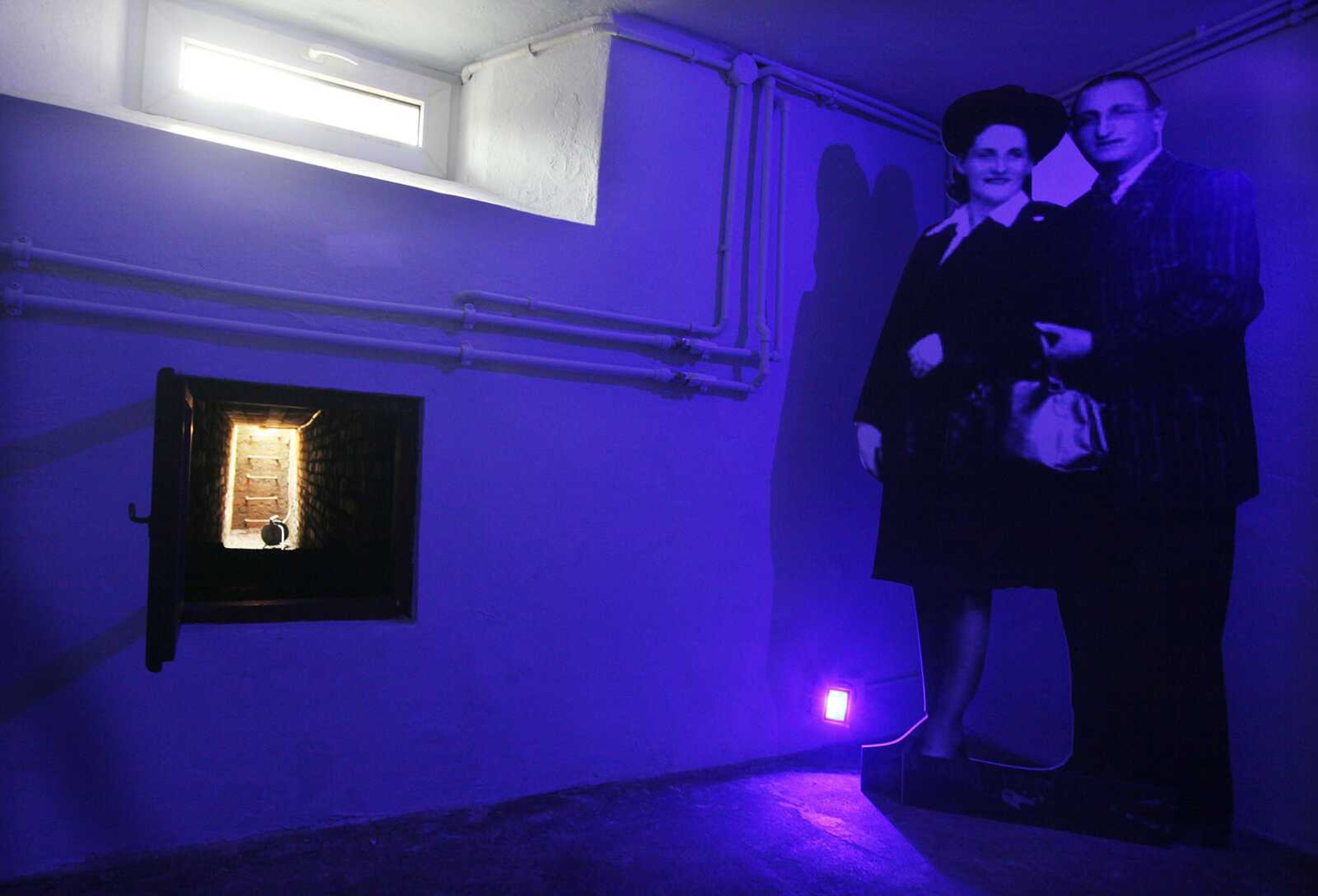 The basement of the villa at the Warsaw zoo where Moshe Tirosh hid for a time in 1943. Today there is a cutout image of Tirosh's parents, who also hid there. (Czarek Sokolowski ~ Associated Press)