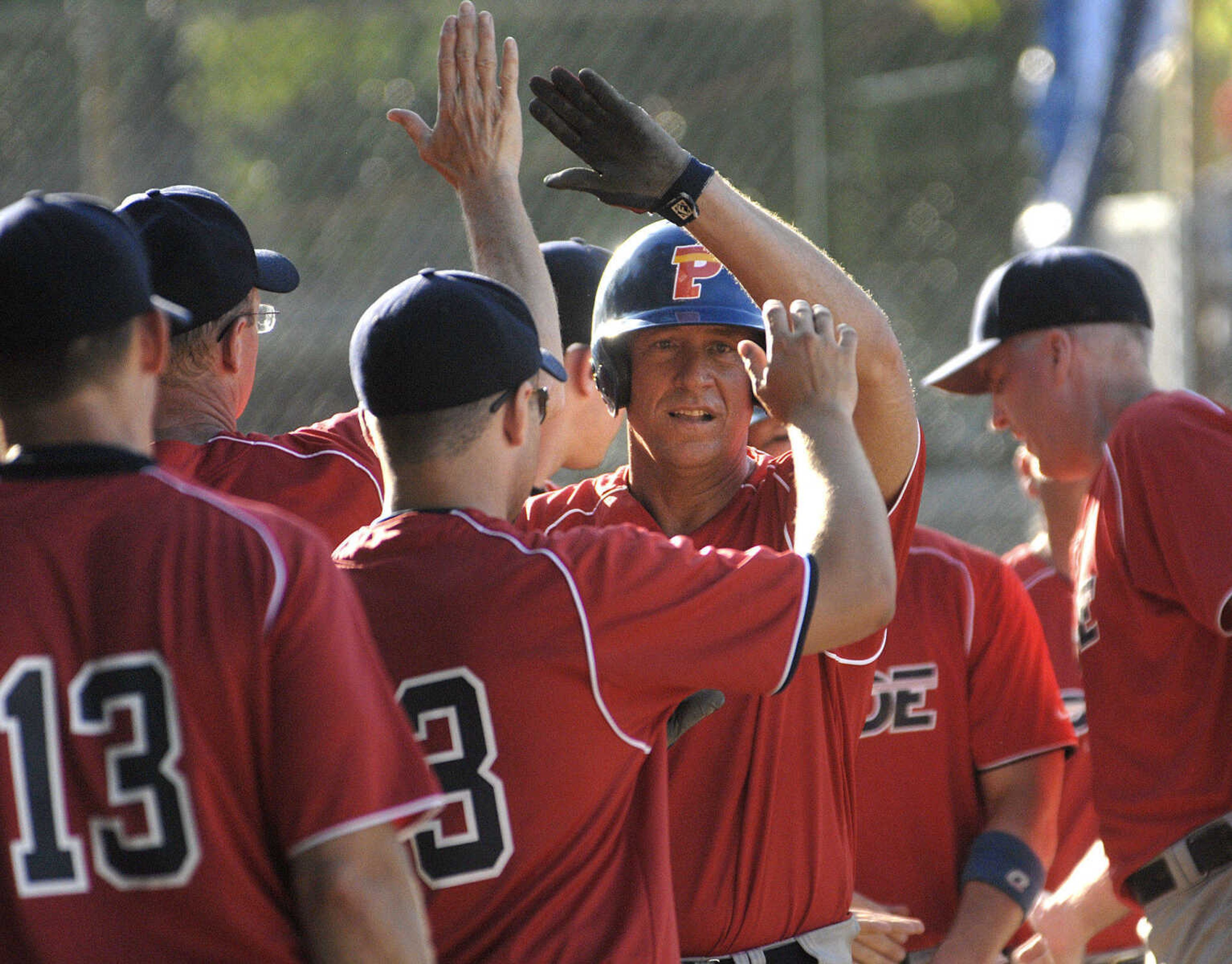 Decatur Pride's David Boys is congratulated after his home run against Nokomis Bud Light during the second inning of the championship game Sunday at the Kelso Klassic.