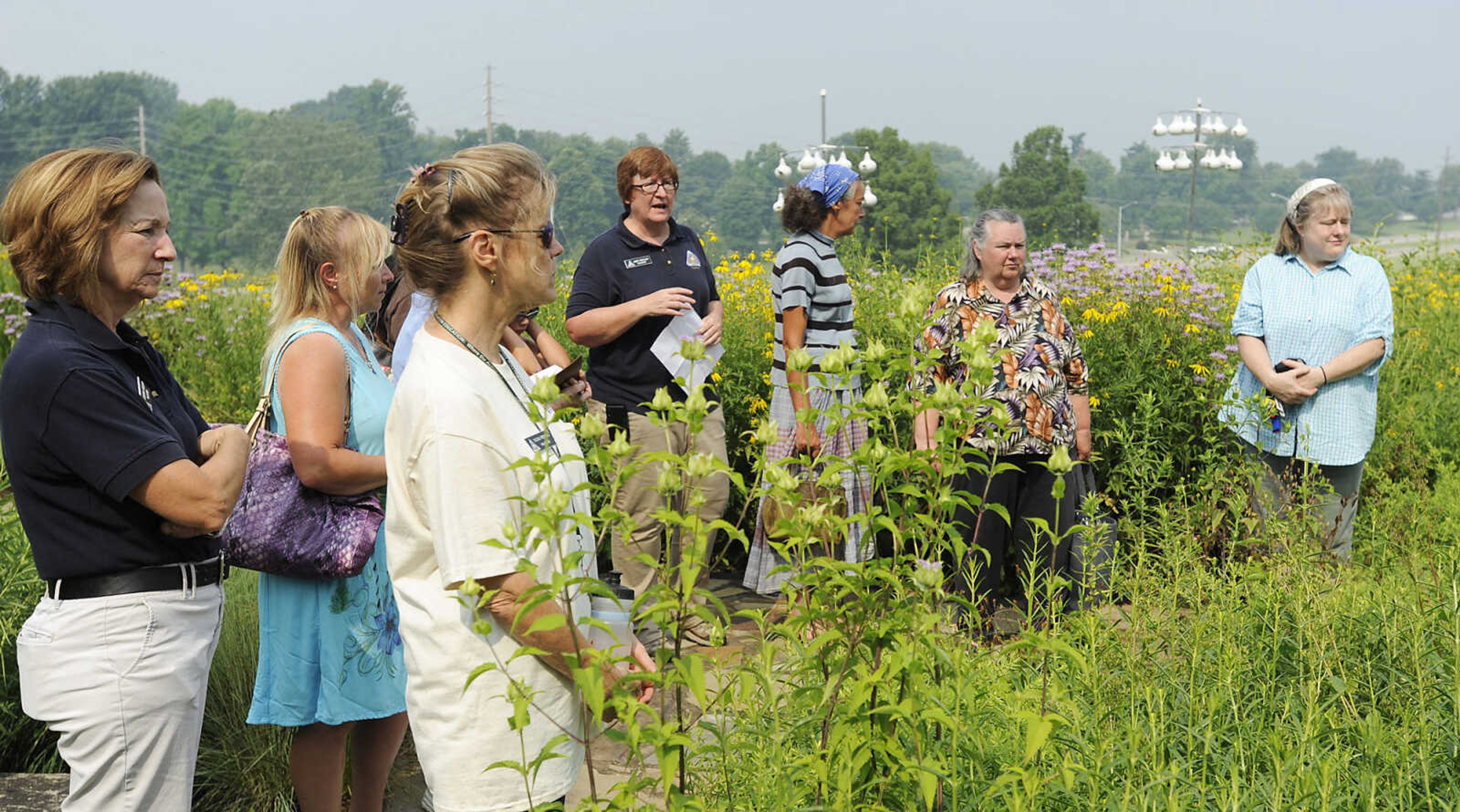 Volunteer Jamie Koehler, blue shirt in middle, leads a group through the garden at the Cape Girardeau Conservation Nature Center during the Garden Tea Party Saturday, June 22, at the nature center located at 2289 County Park Drive in Cape Girardeau. Koehler showed attendees several plants native to Missouri that can be used to make teas before taking them back to the center's patio for a tea party featuring food and drink made from native plants. The party was one of several educational events being held at the center this summer including the Outdoor Adventure Camp, Tuesday, June 25 to Wednesday, June 26, Dutch Oven Drop-by and Tools of the past, Saturday, June 29, Wild Edibles, Saturday, July 6, Gone Frogging, Friday, July 19, and Fishing 101 Saturday, July 27. More information on these and other events can be found on the center's website http://mdc.mo.gov/node/297