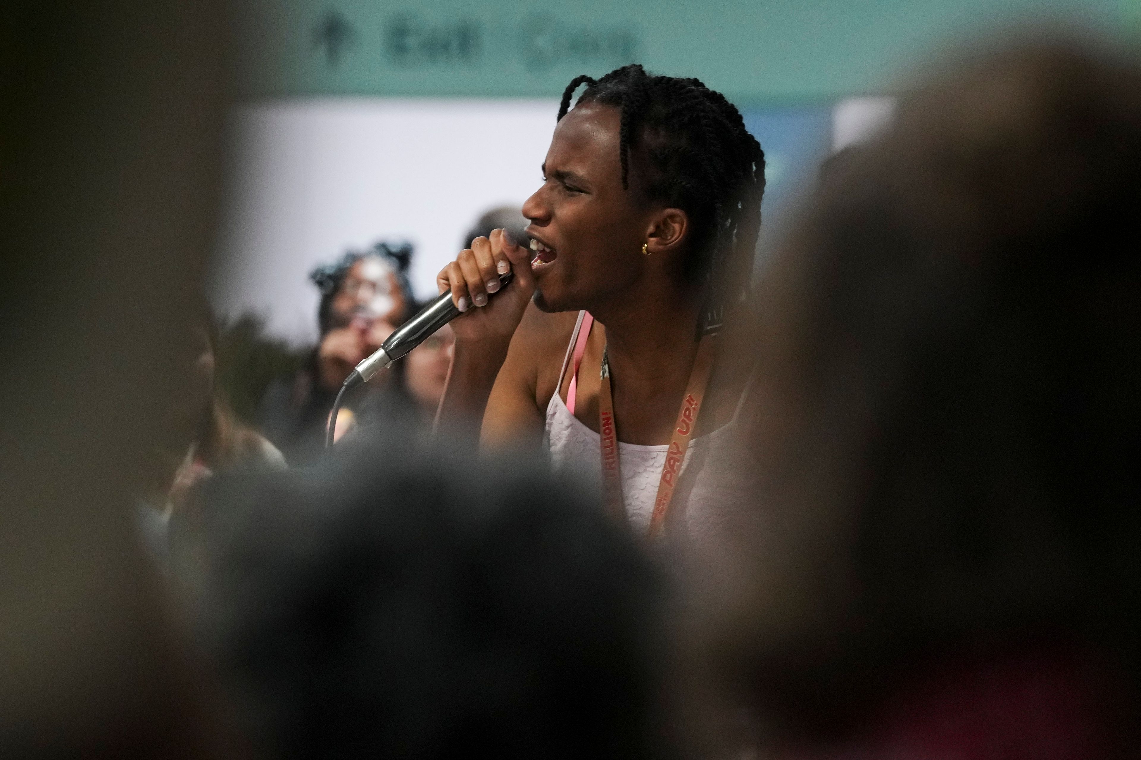 Activist Erica Njuguna speaks during a demonstration on climate finance at the COP29 U.N. Climate Summit, Wednesday, Nov. 20, 2024, in Baku, Azerbaijan. (AP Photo/Peter Dejong)