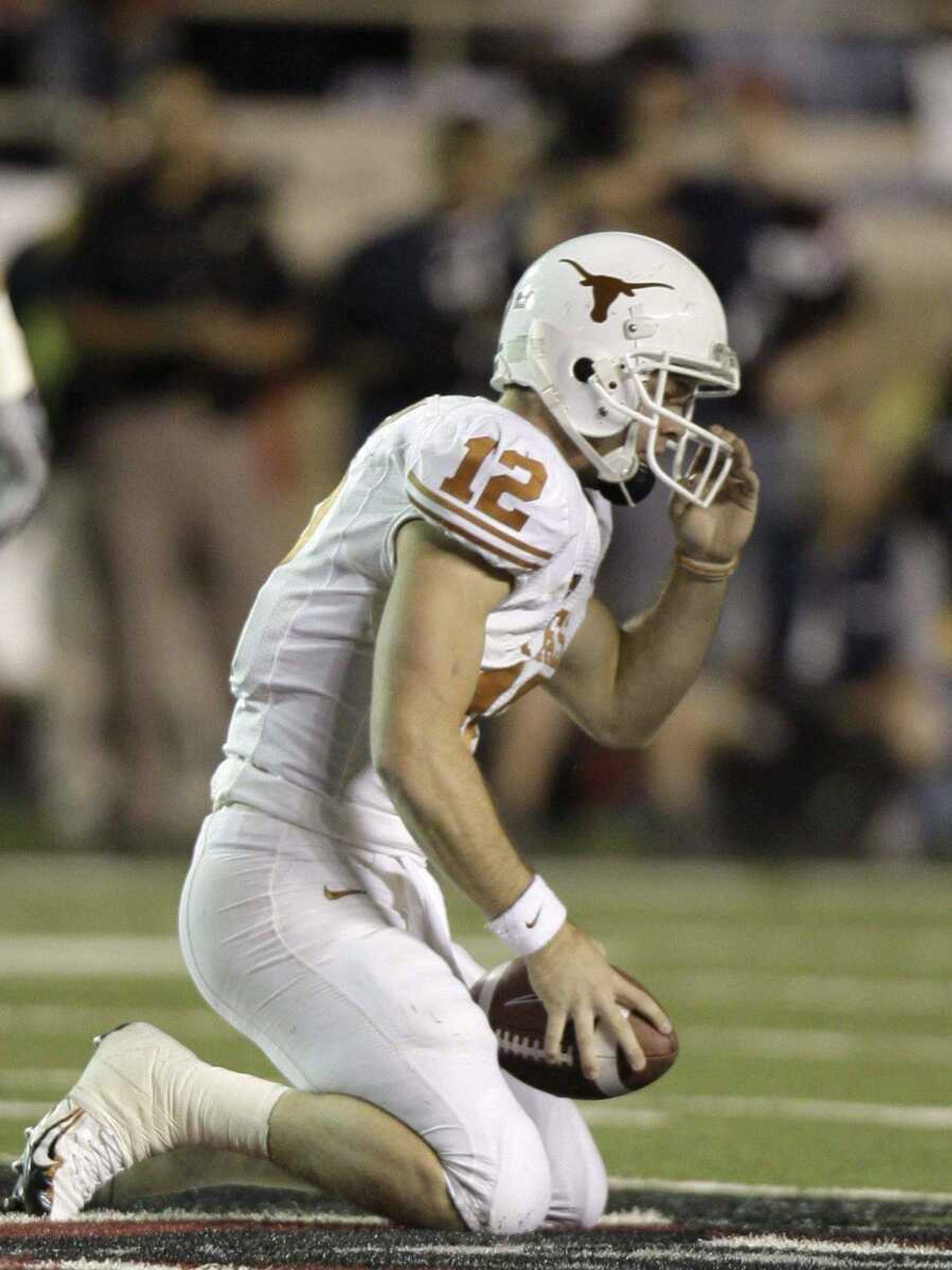 Texas quarterback Colt McCoy slowly gets up off the field after he was sacked in the fourth quarter against Texas Tech in an NCAA college football game in Lubbock, Texas, Saturday, Nov. 1, 2008. Texas Tech won 39-33. (AP Photo/LM Otero)