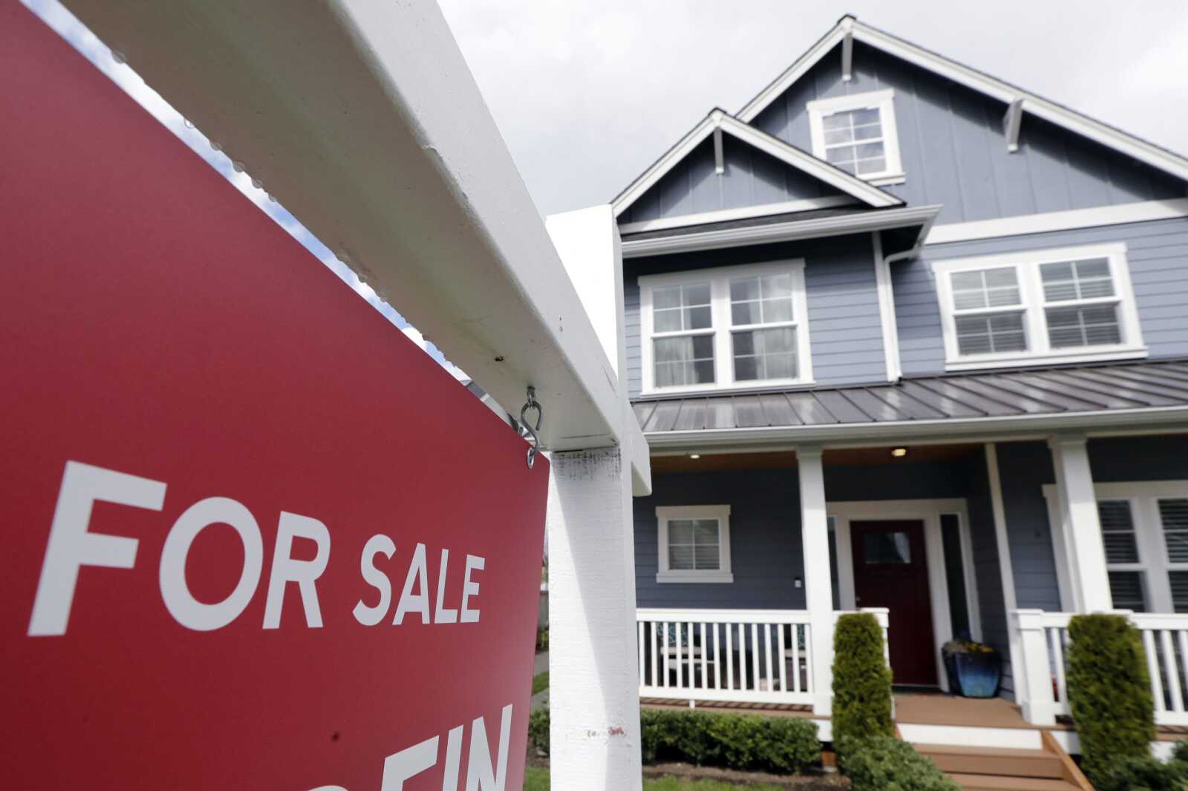 FILE - In this April 1, 2020 photo, a  For Sale  sign stands in front of a home that is in the process of being sold in Monroe, Wash., outside of Seattle. U.S. home sales rose a record-breaking 24.7% in July, extending last monthÂ‚Ã„Ã´s rebound after the coronavirus pandemic all but froze the housing market this spring, the National Association of Realtors said Friday, Aug. 21, 2020. (AP Photo/Elaine Thompson, File)