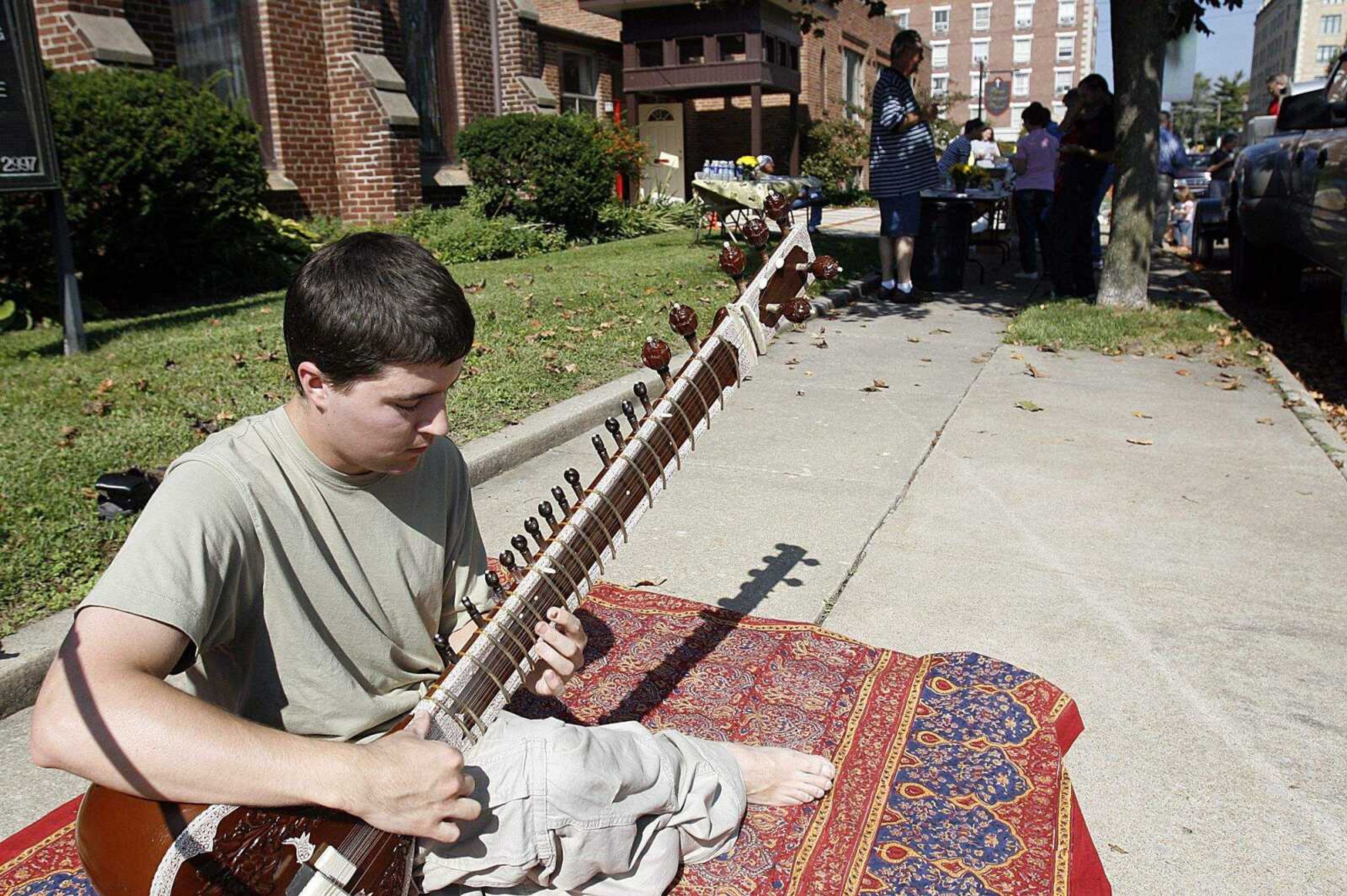 ELIZABETH DODD ~ edodd@semissourian.com
Chris Stephens, 25, of Cape Girardeau, plays the sitar for musical entertainment at the Neighborhood Connections Block Party.