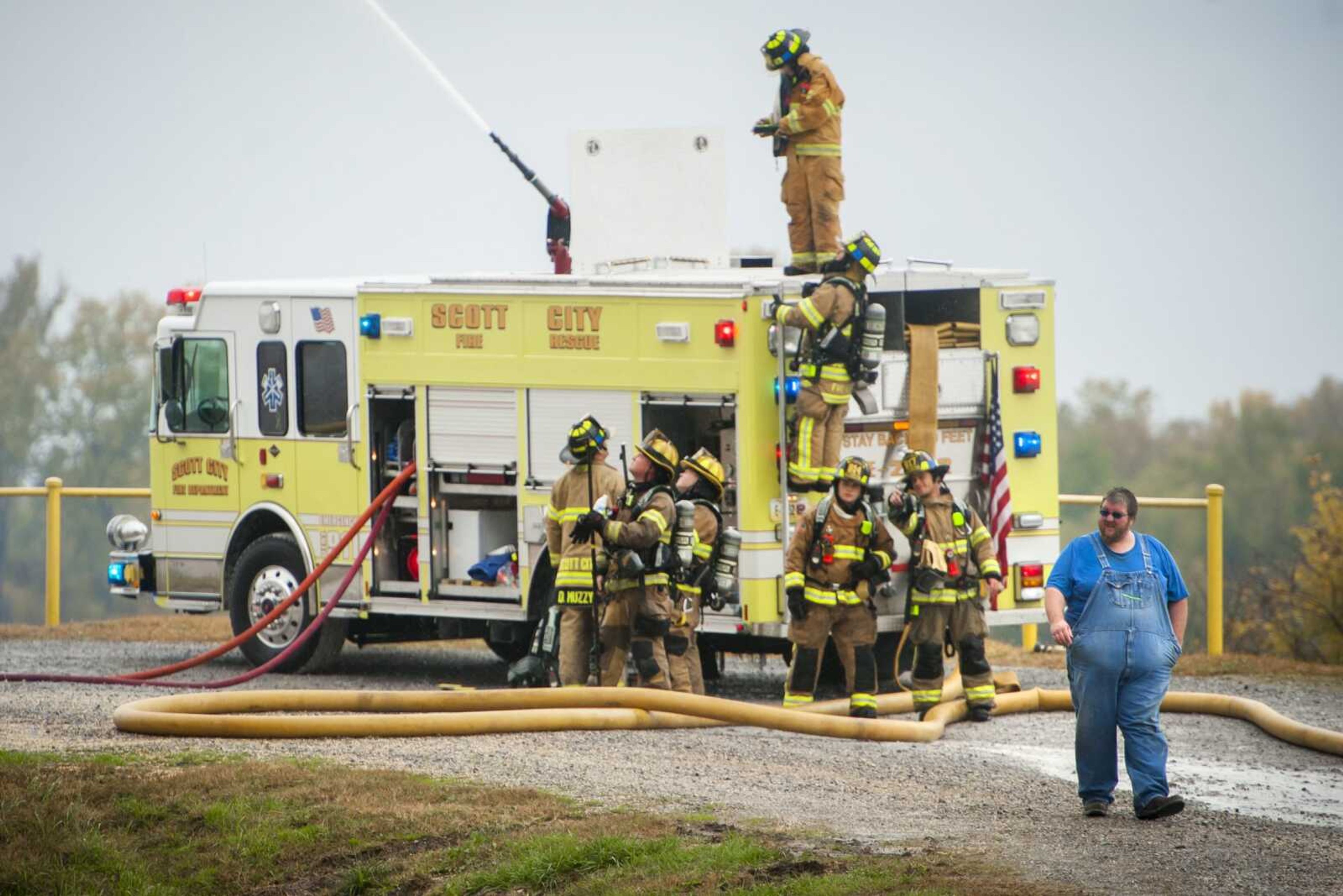 Members of the Scott City Fire Department battle flames during a two-alarm fire Wednesday at Midwest Grain and Barge in Scott City.