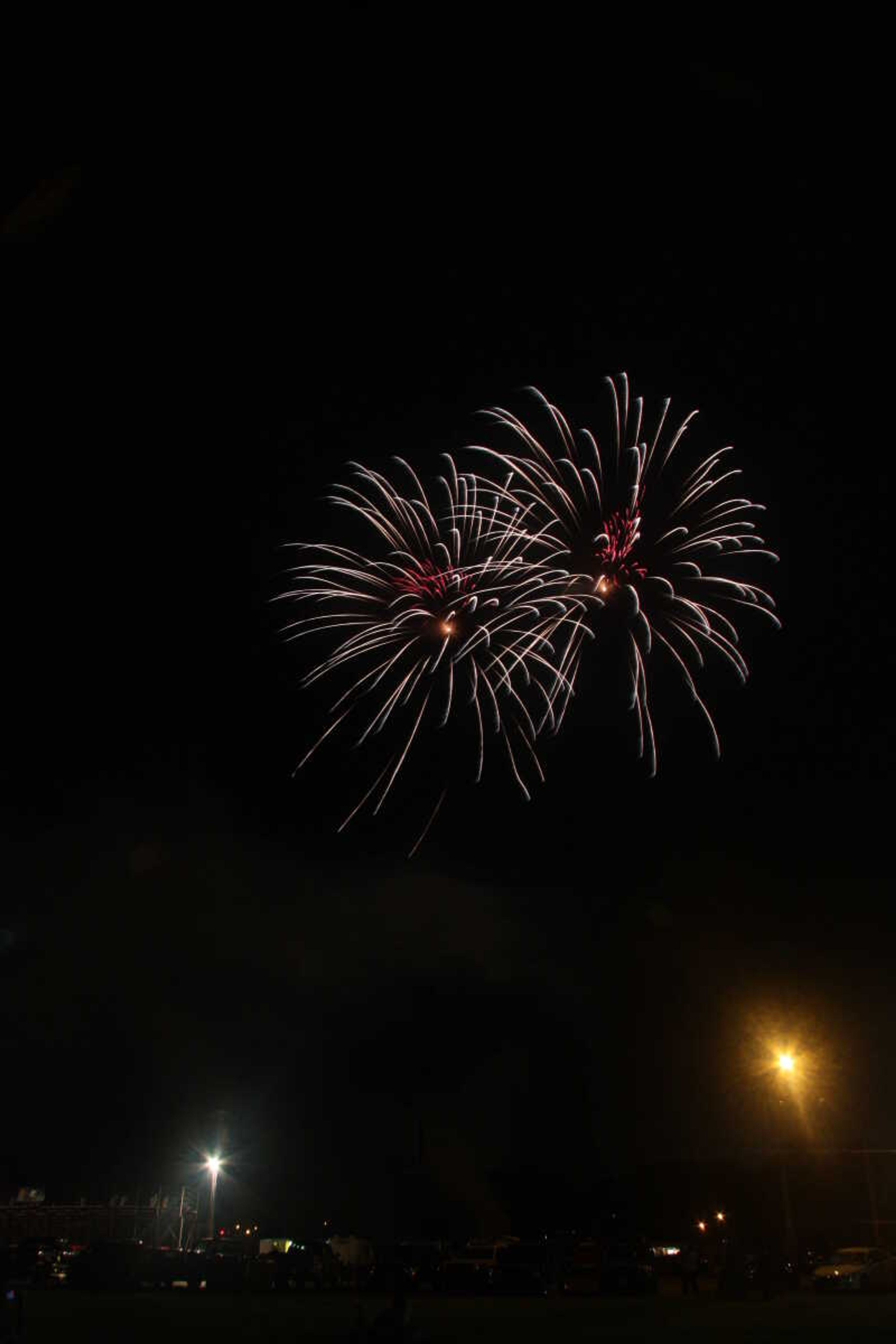 Picture of the fireworks display in Cape Girardeau's Arena Park, taken from a field south of the park.