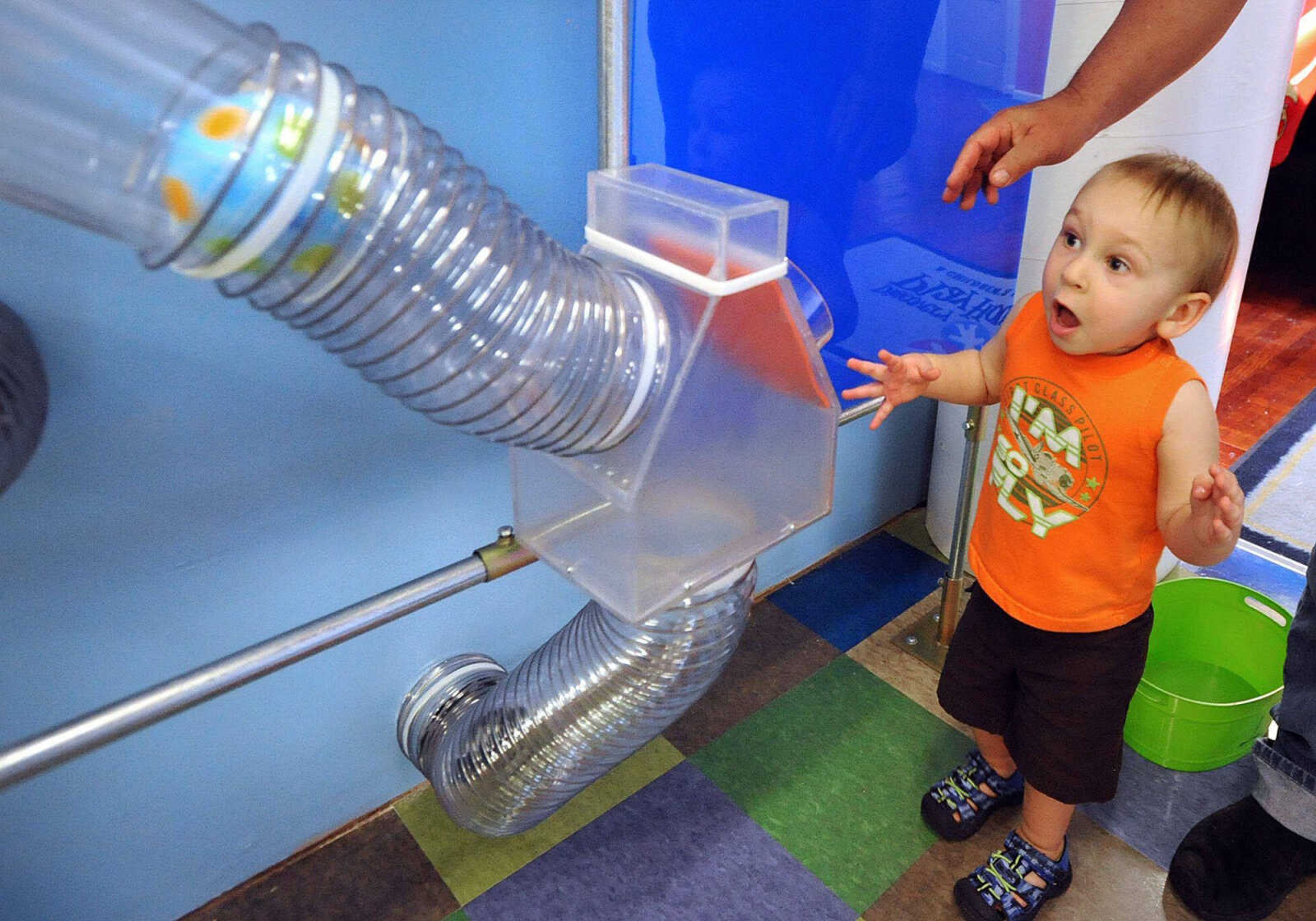 Devin Terrell, 2, watches in amazement as his ball is sucked through the tube at Discovery Playhouse in Cape Girardeau.
(Laura Simon)