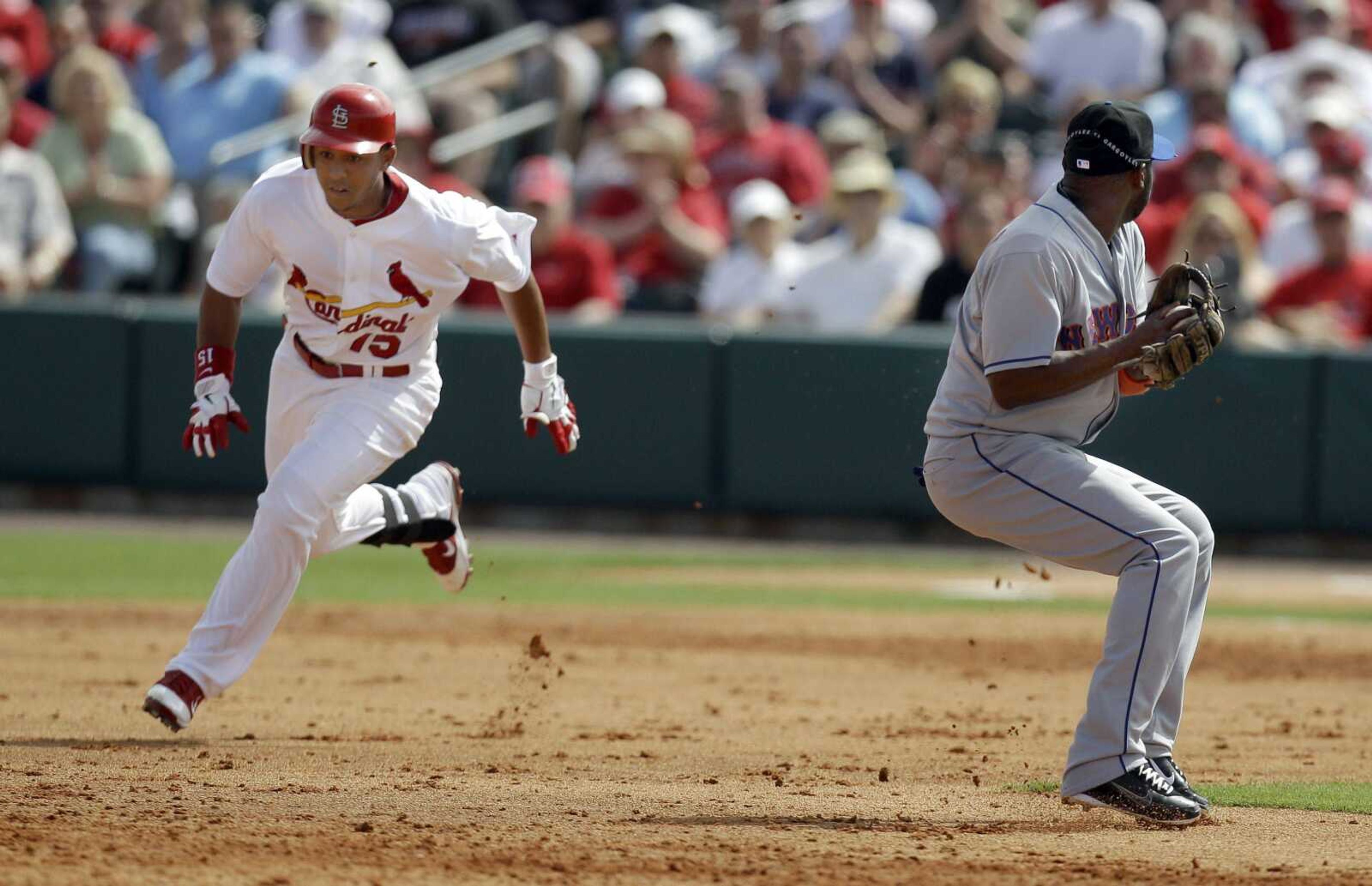 Cardinals baserunner Jon Jay, left, races into second base for a double past Mets second baseman Luis Castillo during the third inning Wednesday in Jupiter, Fla. (JEFF ROBERSON ~ Associated Press)