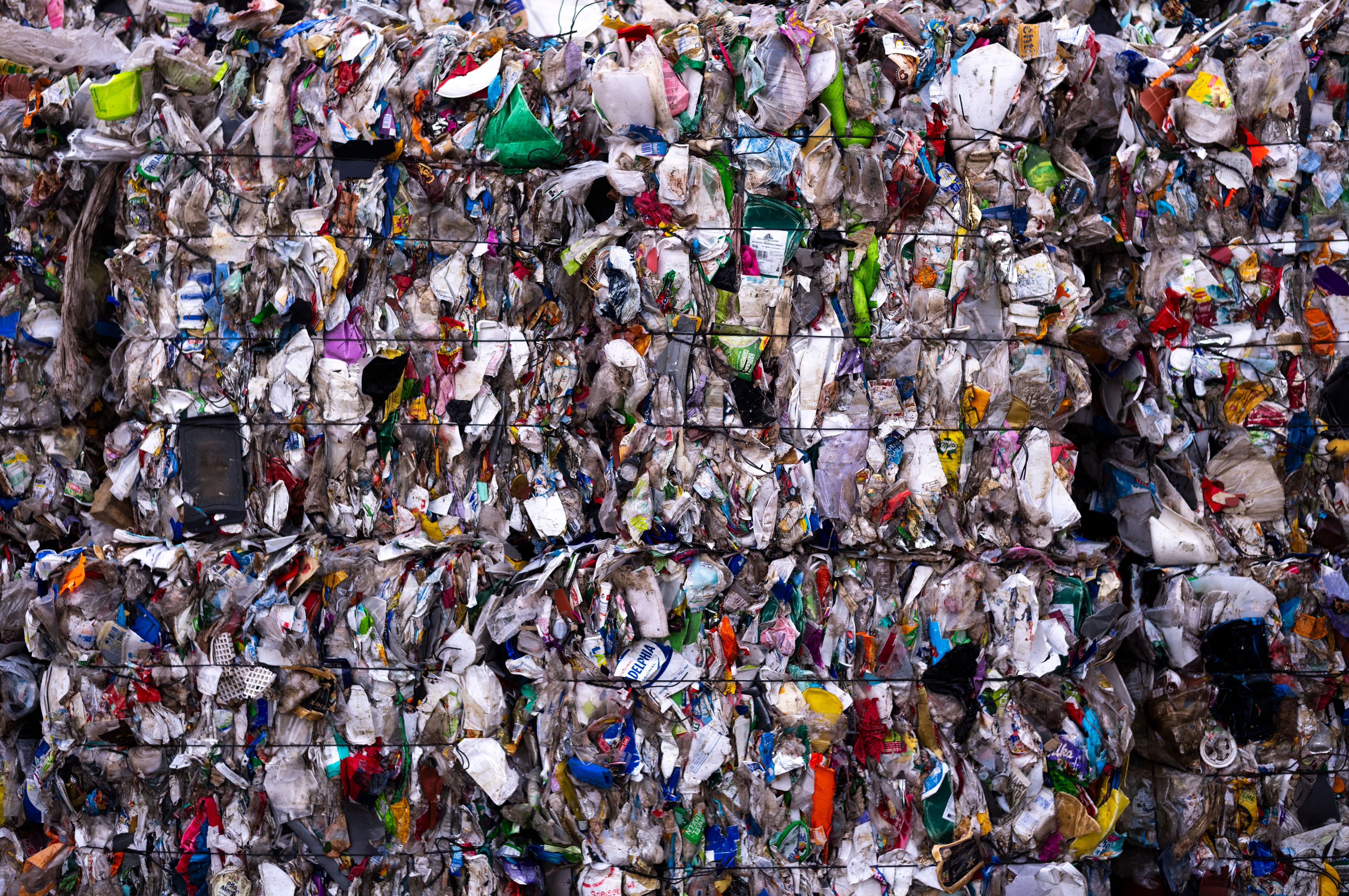 Plastic garbage bales stand at the courtyard of the Interzero plastic sorting facility facility in Berlin, Germany, Wednesday, Nov. 27, 2024. (AP Photo/Markus Schreiber)