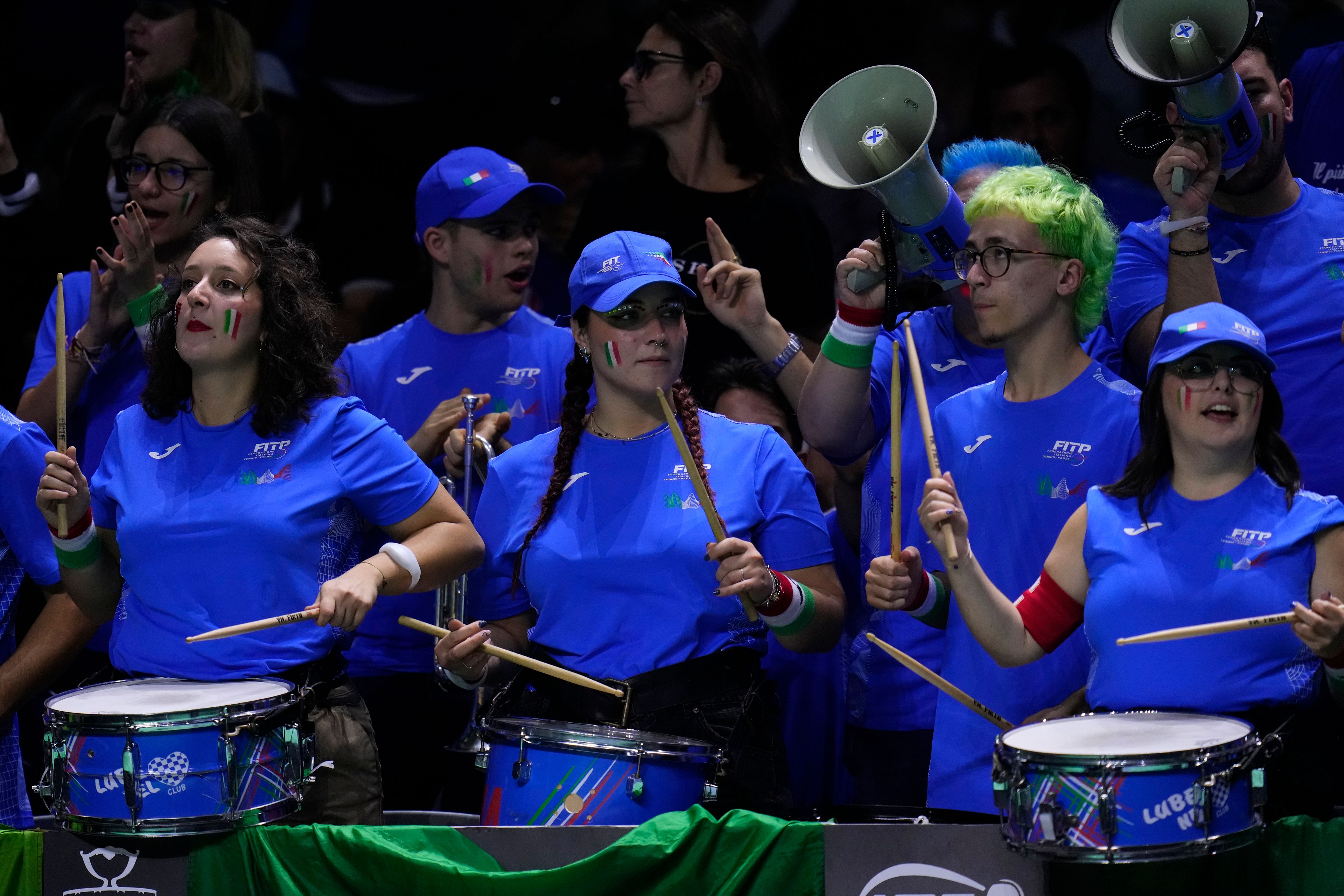 Supporters of Italy's Jannik Sinner play the drums as he plays Netherlands' Tallon Griekspoor during the Davis Cup final tennis match between Netherlands and Italy at the Martin Carpena Sports Hall in Malaga, southern Spain, Sunday, Nov. 24, 2024. (AP Photo/Manu Fernandez)