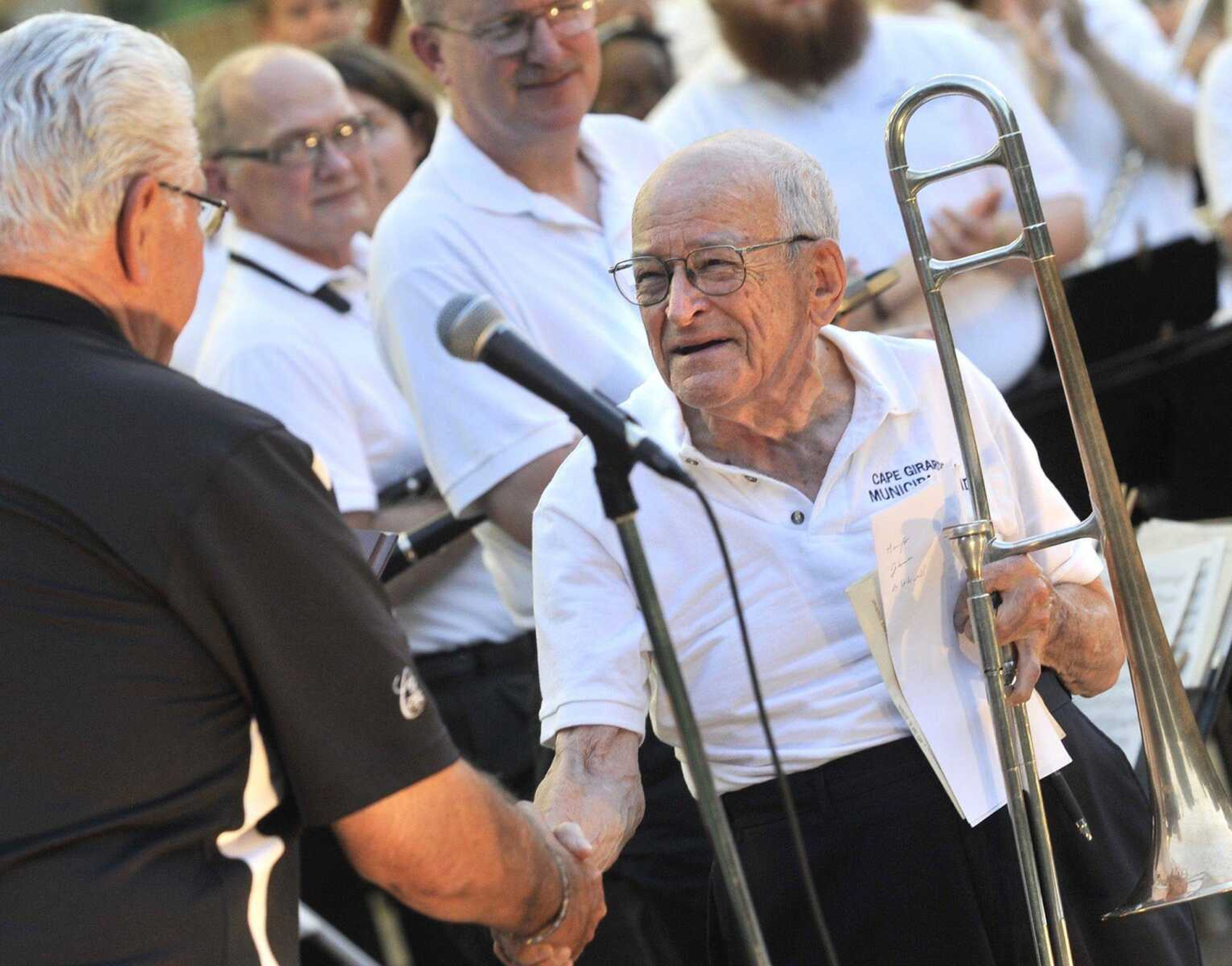 Mayor Harry Rediger presents Dr. Dan Cotner with a proclamation honoring Cotner in his 74th year with the Cape Girardeau Municipal Band on Wednesday, June 12, 2013 at the Capaha Park bandshell. (Fred Lynch)