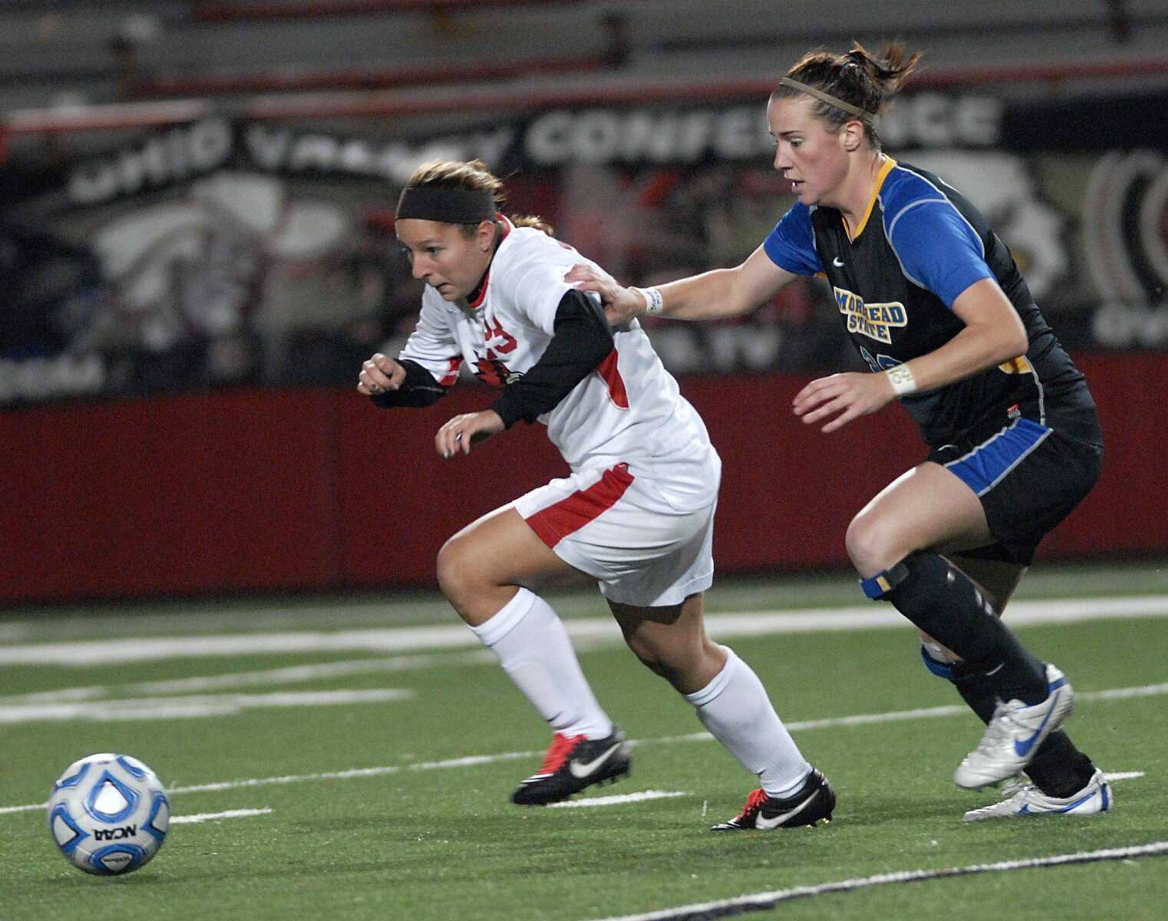 Southeast Missouri State's Lauren Bozesky, left, and Morehead State's Brittany MacLennan chase the ball during the second half of their OVC tournament semifinal Friday at Houck Stadium. (Kristin Eberts)