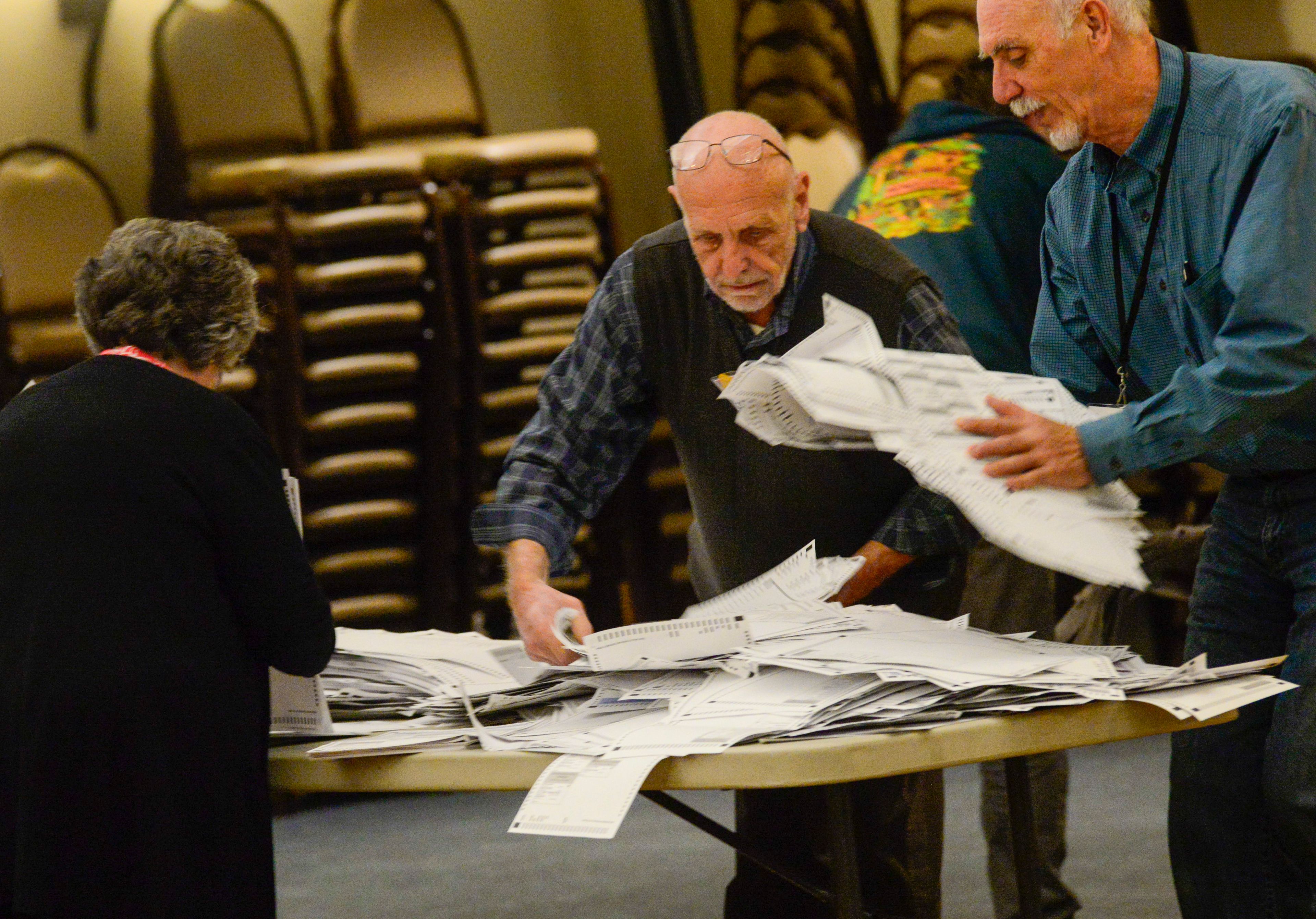 Election officials recount the vote to make sure the counts match at a polling station in Brattleboro, Vt., on Tuesday, Nov. 5, 2024. (Kristopher Radder/The Brattleboro Reformer via AP)