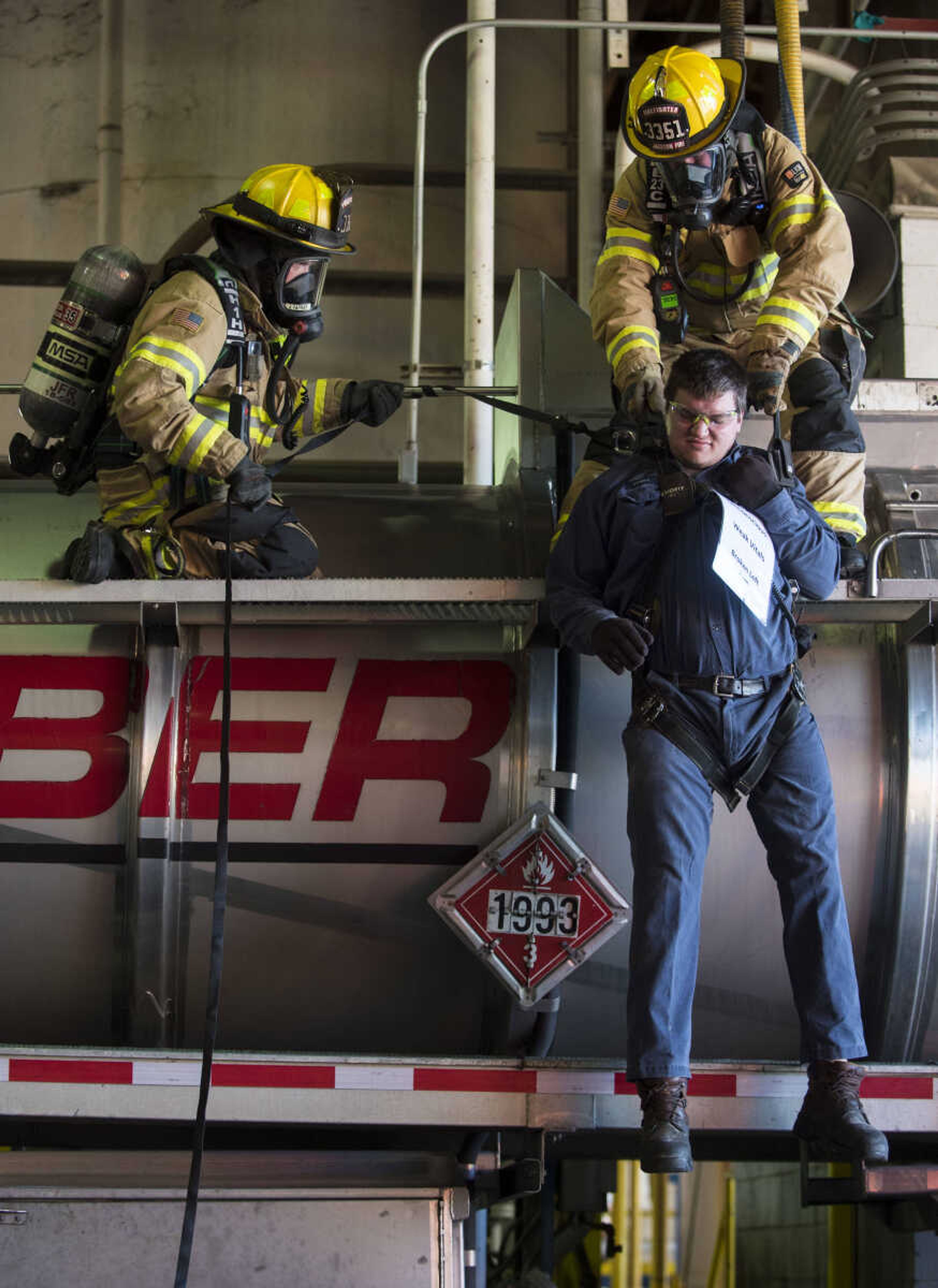 SEMO Homeland Security Response Team members Justin Farrar, above left, and Ron Kiplinger, above right, lower mock victim Corey Gettings onto a stretcher during a hazmat training exercise on Wednesday, Oct. 17, 2018 at the Cape Girardeau Buzzi Unicem cement plant.