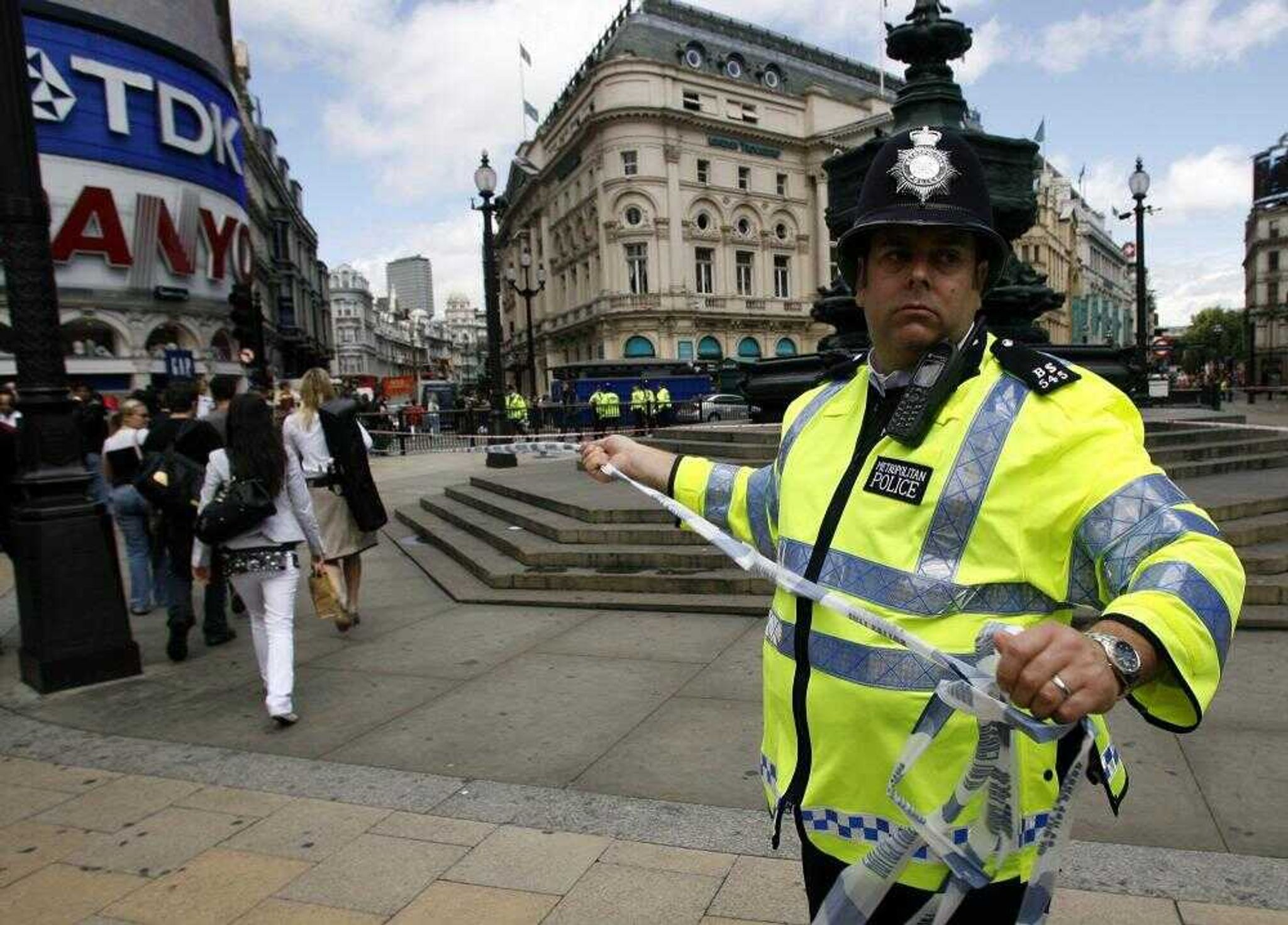 A police officer cordoned off the Piccadilly Circus area of central London on Friday. British police defused a bomb found in a car in central London on Friday, and the new government called an emergency meeting of senior security chiefs to investigate the situation. (HORIZ AKIRA SUEMORI &#8212;Associated Press)