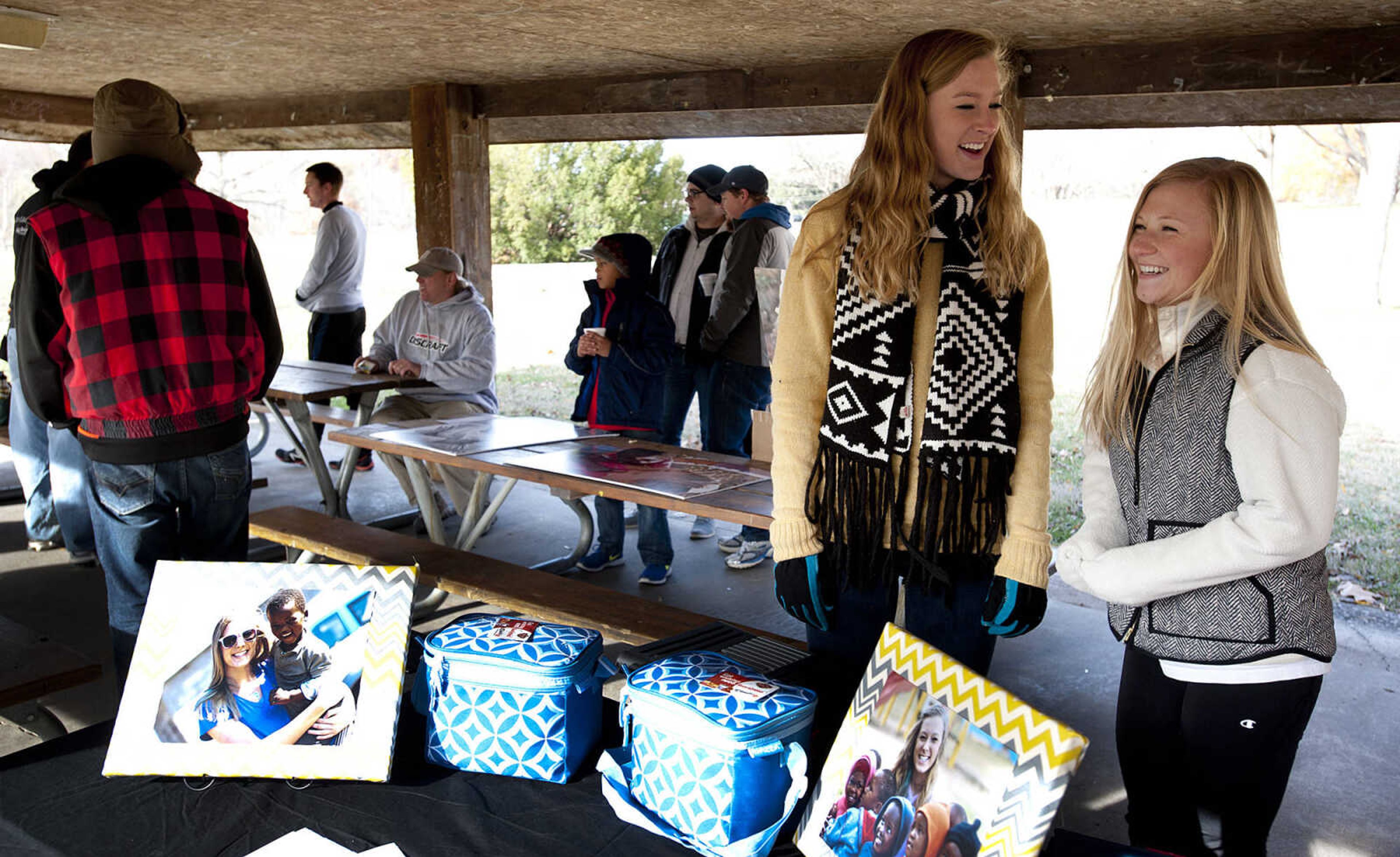 Sarah Stroup, right, and Samantha Easley, 17, before the start of the Fountain of Life Disc Golf Tournament Sunday, Nov. 24, at Capaha Park in Cape Girardeau. Stroup estimated that approximately 30 people played in the tournament which raised around $2,500 which will go towards construction of a fresh water well for a village in Swaziland, Africa.