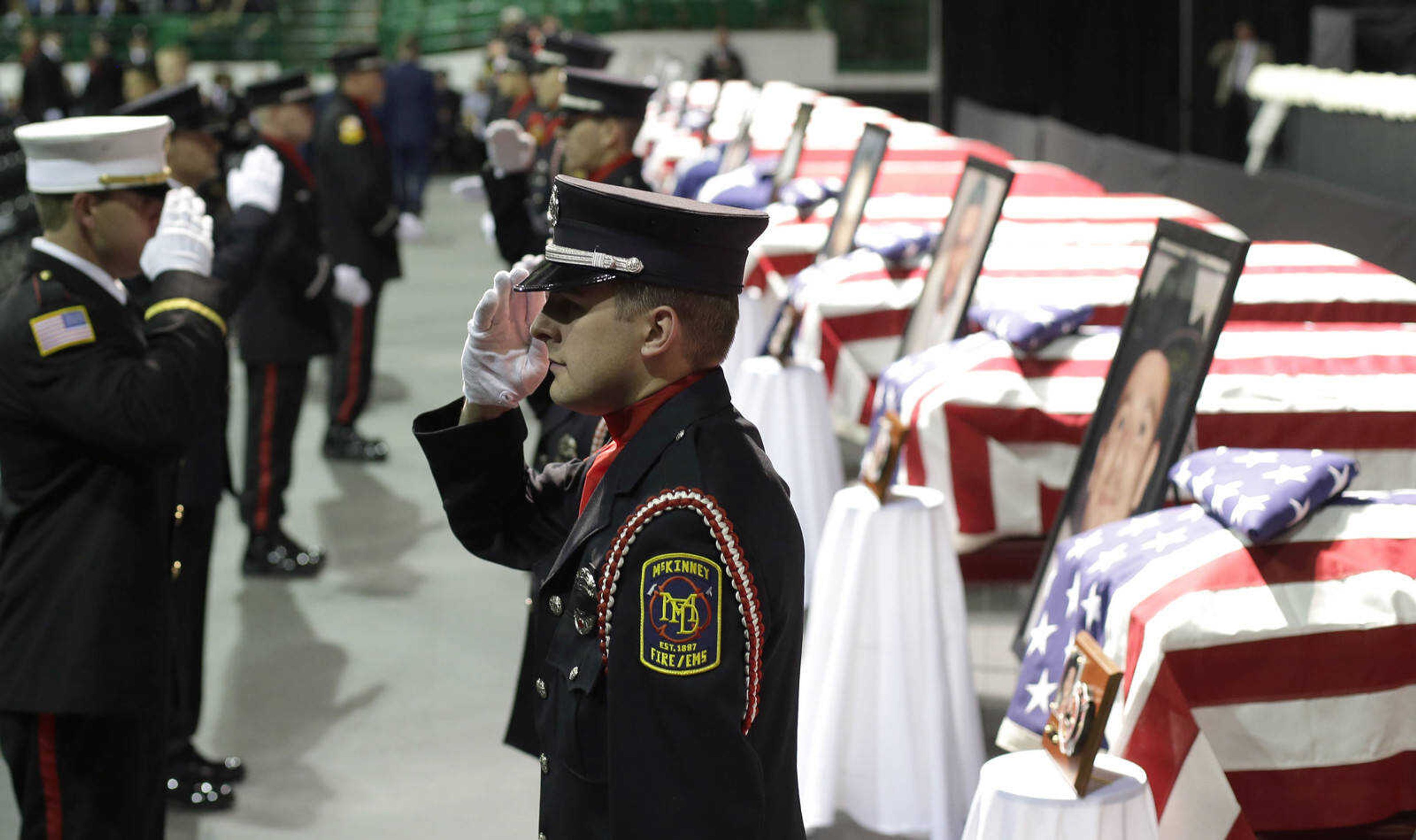 Honor guard salute as they change shift prior to a memorial service for first responders who died in last week's fertilizer plant explosion in West, Texas, Thursday, April 25, 2013, in Waco, Texas.  President Barack Obama, U.S. Sen. John Cornyn and Texas Gov. Rick Perry are set to speak at Thursday's memorial at Baylor University's Ferrell Center in Waco. Firefighters and other first responders were among those killed when a fire at the plant erupted in an explosion last week. Hundreds of people were injured. (AP Photo/Eric Gay)