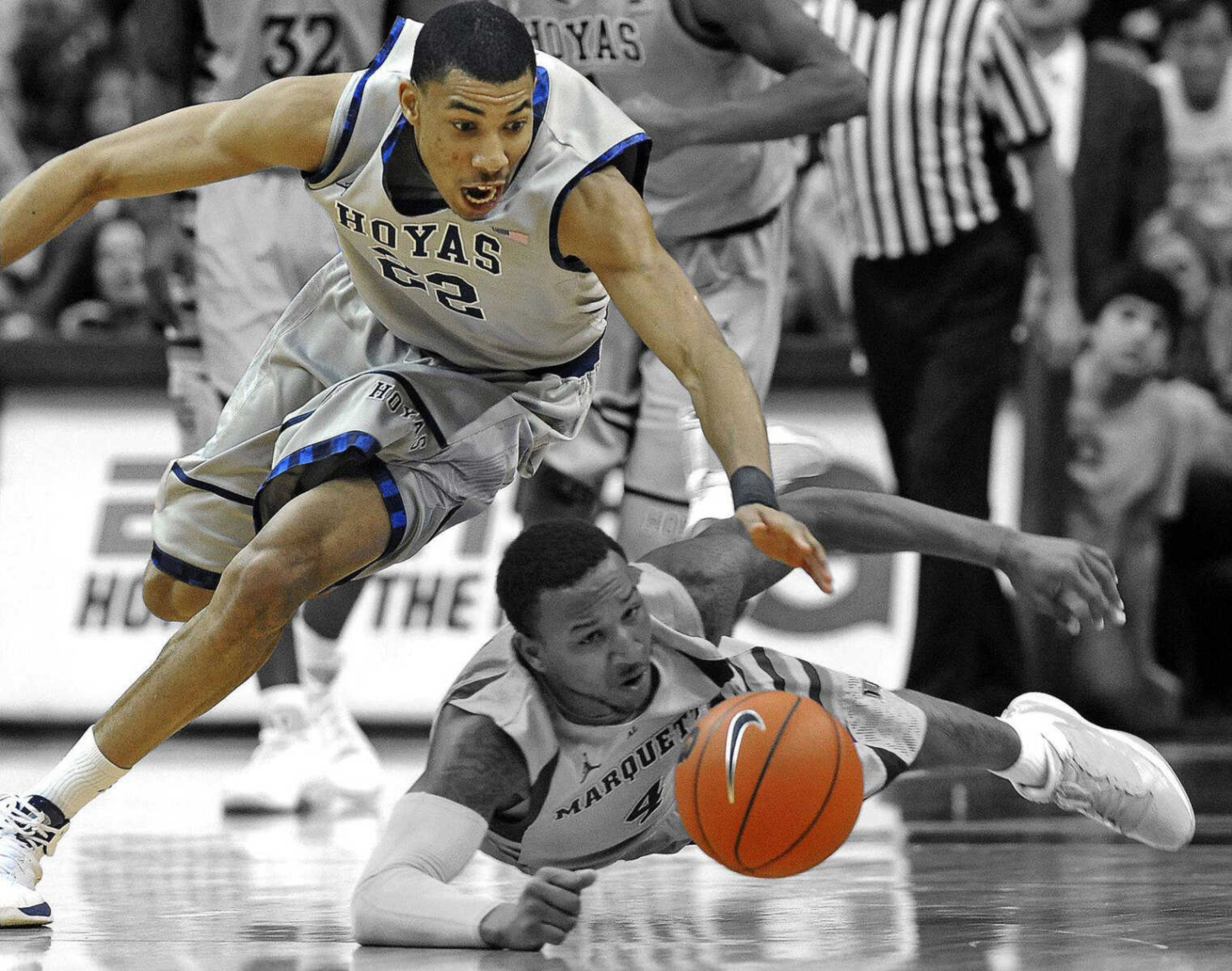 Marquette's Todd Mayo (4) and Georgetown's Otto Porter (22) scramble for a loose ball during second half of their NCAA college basketball game, Wednesday, Jan. 4, 2012, in Washington. (AP Photo/Richard Lipski)