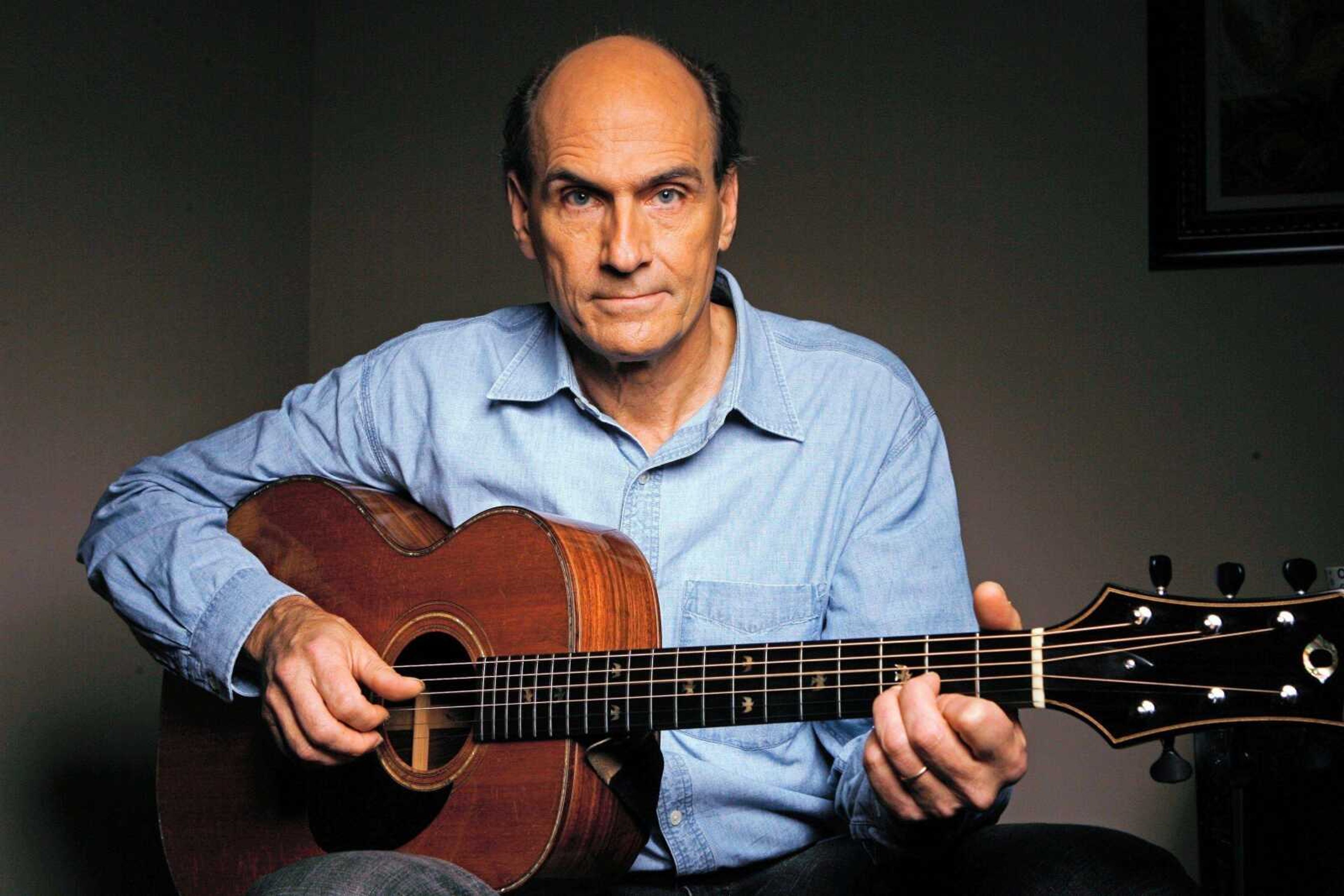 Musician James Taylor played his guitar at the NBC Studios in Burbank, Calif. James Taylor's new CD/DVD set "One Man Band" is a musical self-portrait that takes him back to the start of his career in the late 1960s. (Damian Dovarganes ~ Associated Press)